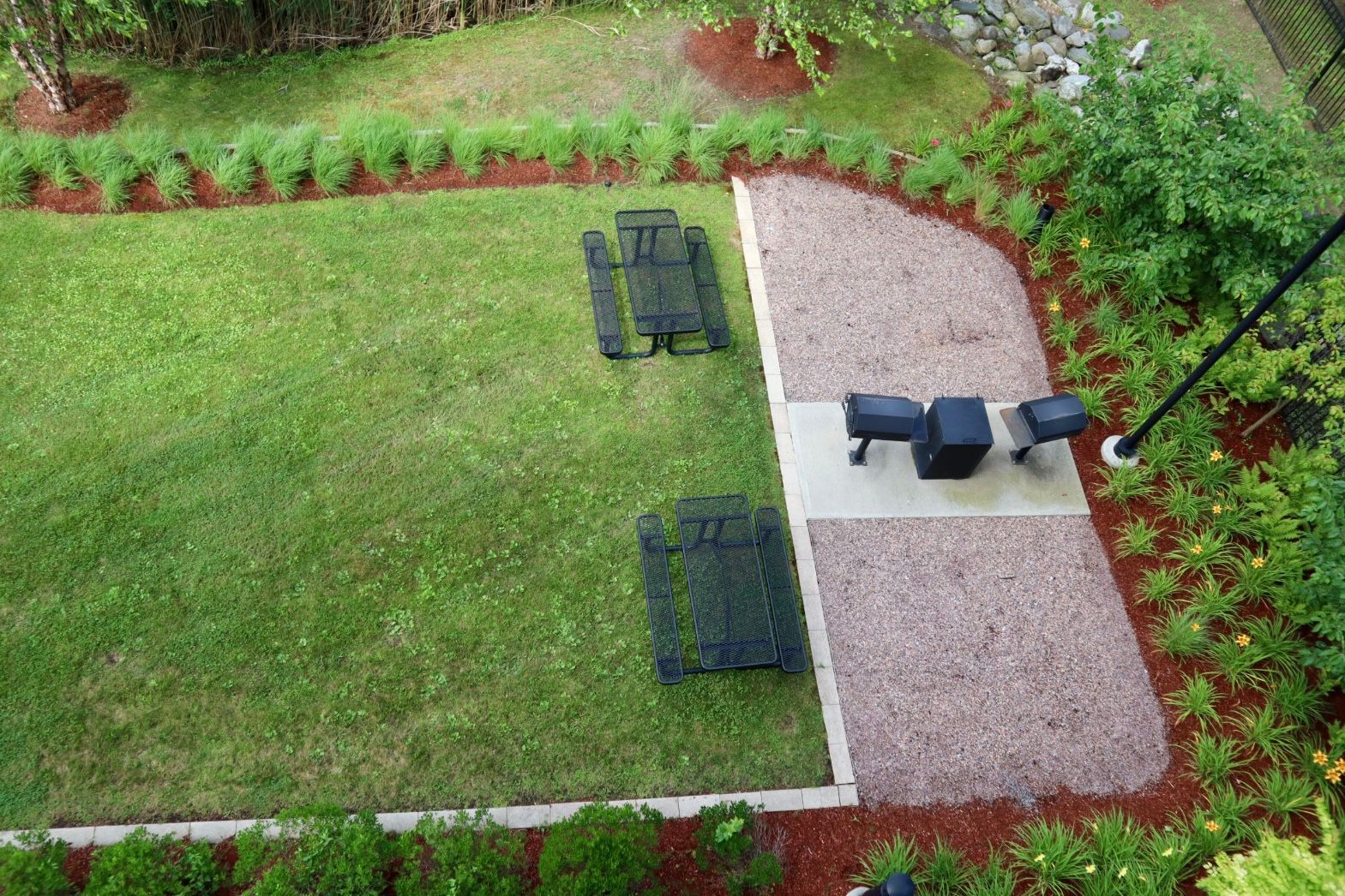 An aerial view of a backyard with a table and chairs.