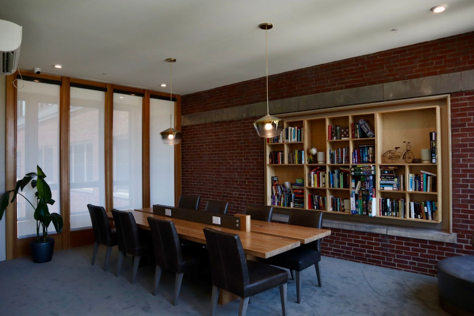 A dining room with a long table and chairs