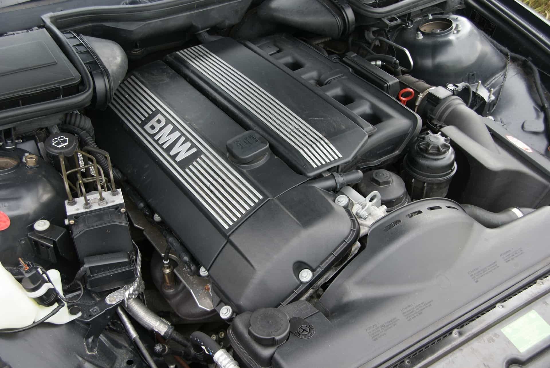 A close up of a bmw engine with the hood open | Doctor of Motors