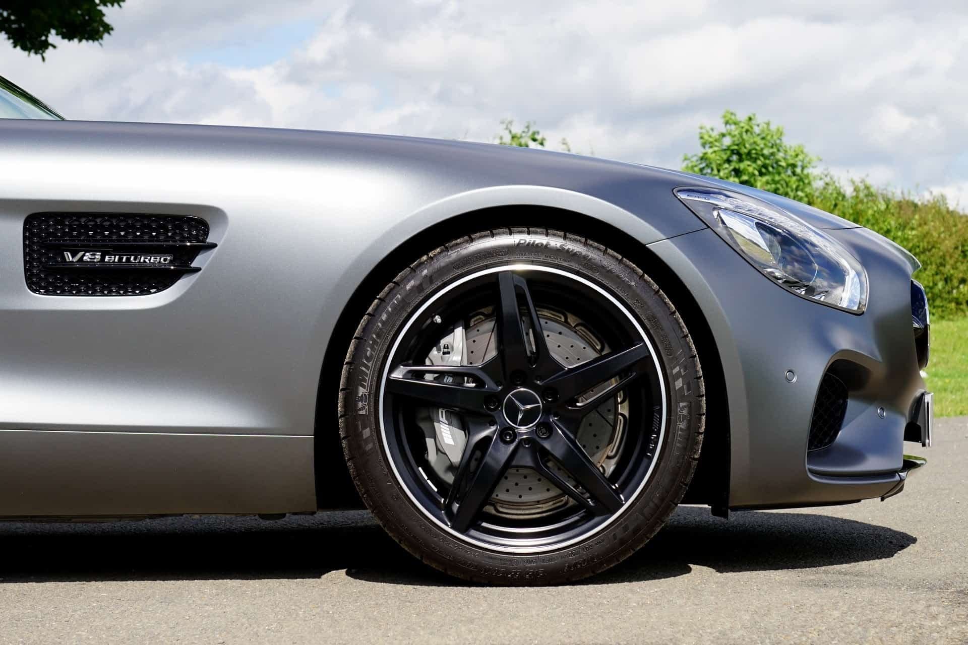 A close up of a car 's wheel and tire on a road | Doctor of Motors