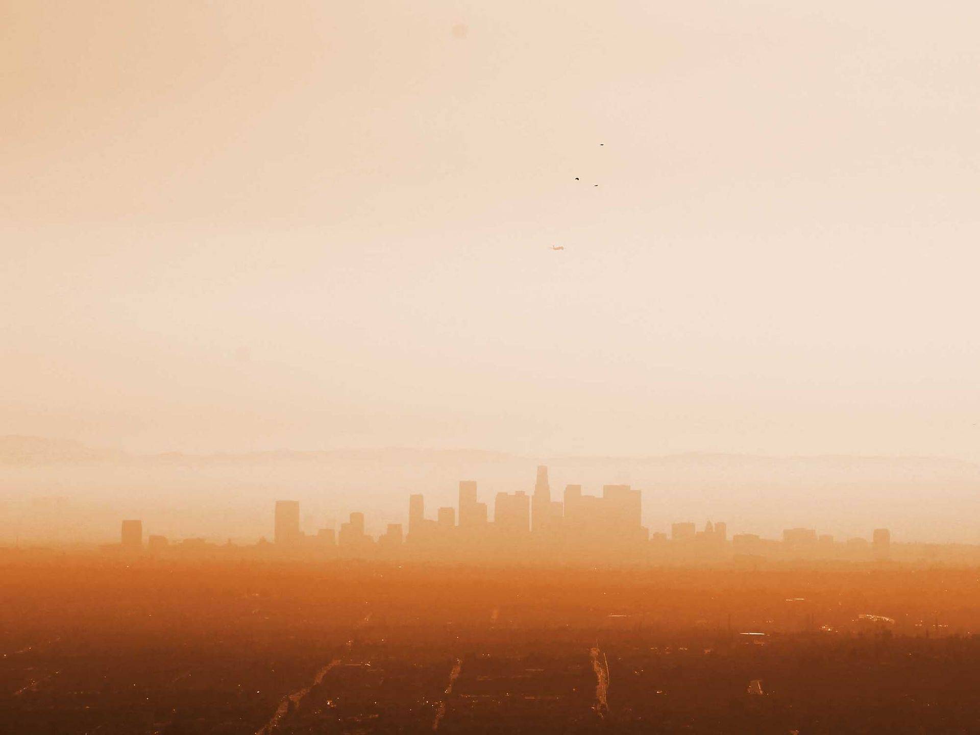 An aerial view of a city skyline at sunset | Doctor of Motors