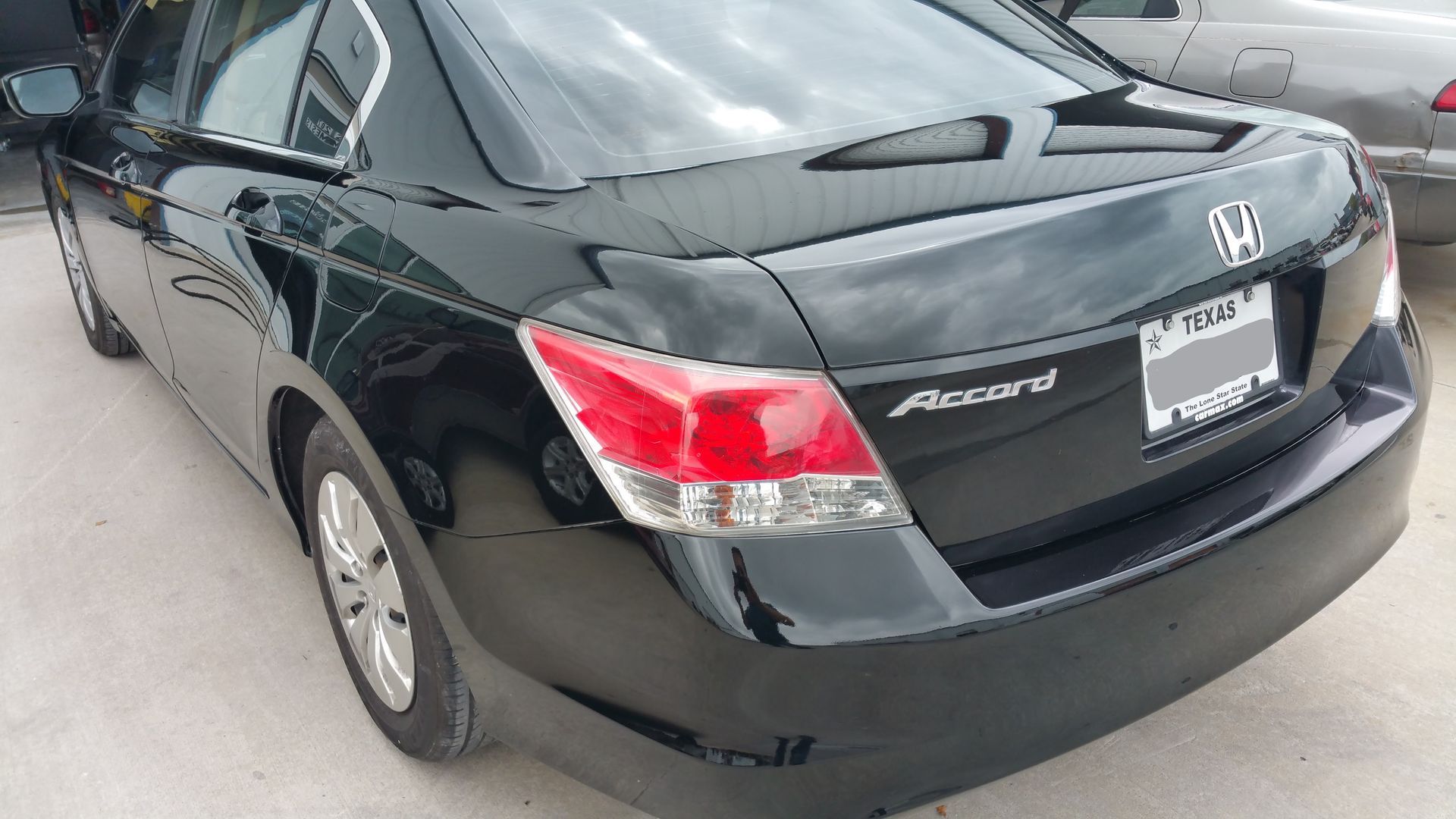 Black Honda Civic sedan parked outdoors, rear three-quarter view.