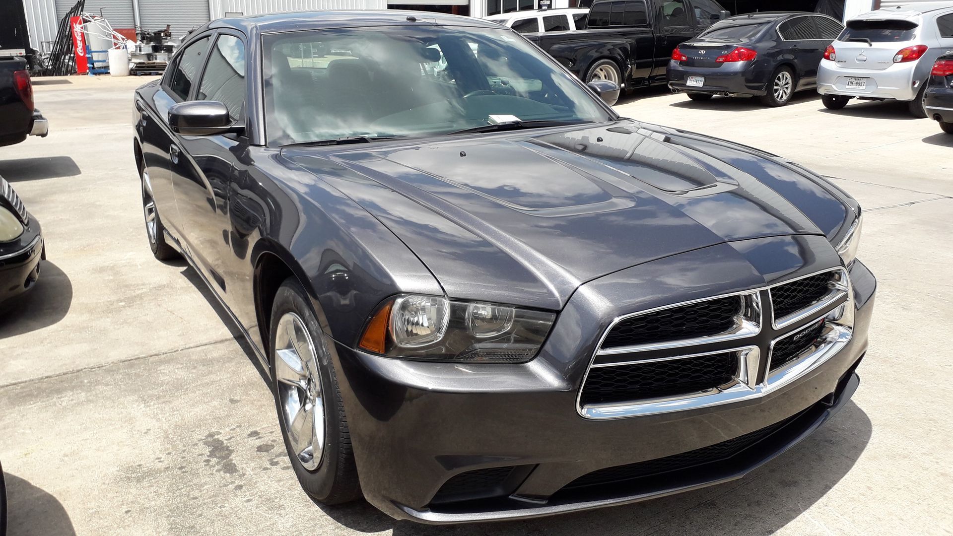 Dark gray Dodge Charger parked in a car lot, front view