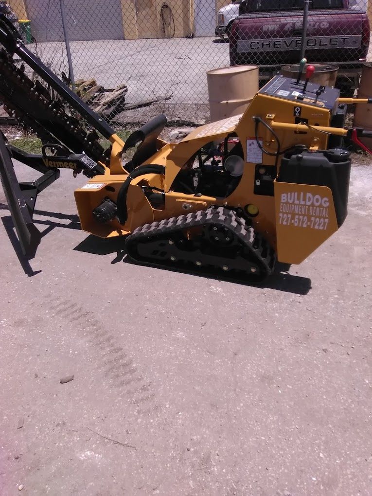 A yellow bulldog tractor is parked on the side of the road