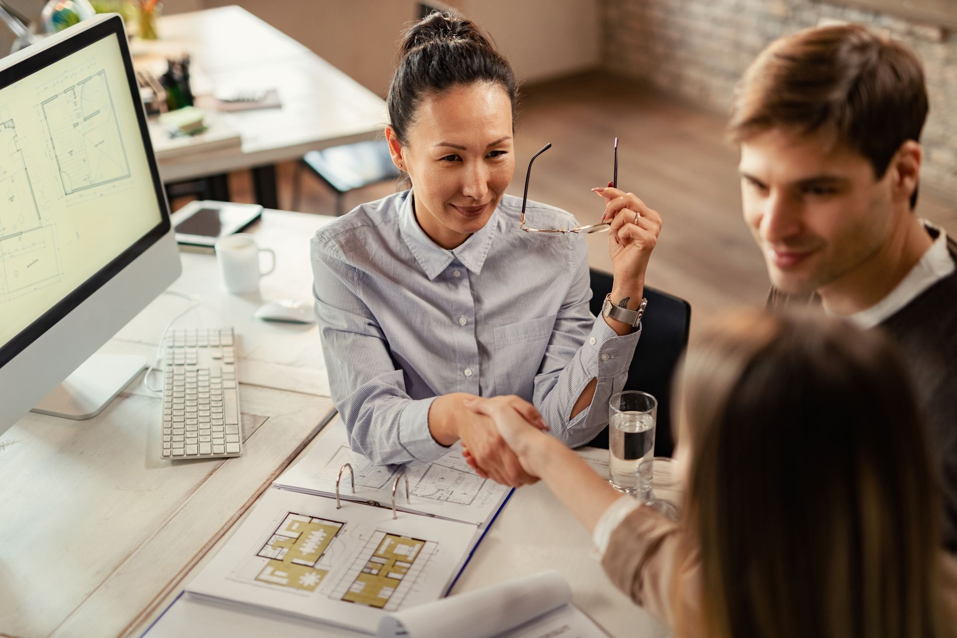 Homeowners discussing property value with certified residential appraiser