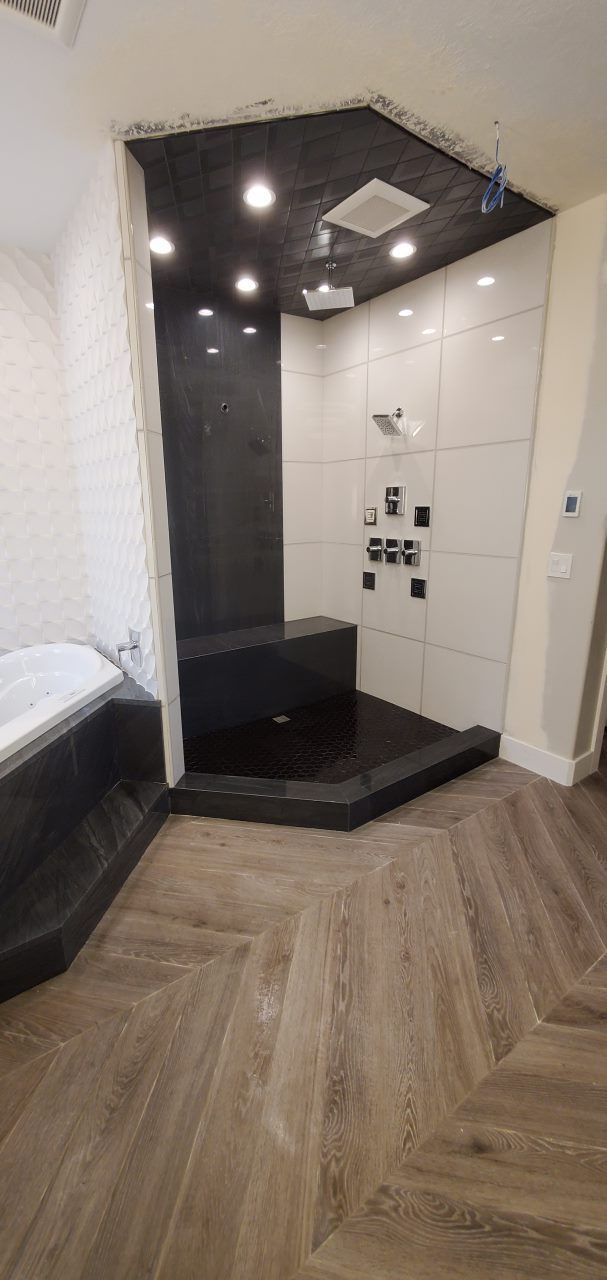 A white truck is parked in a parking lot next to a building.