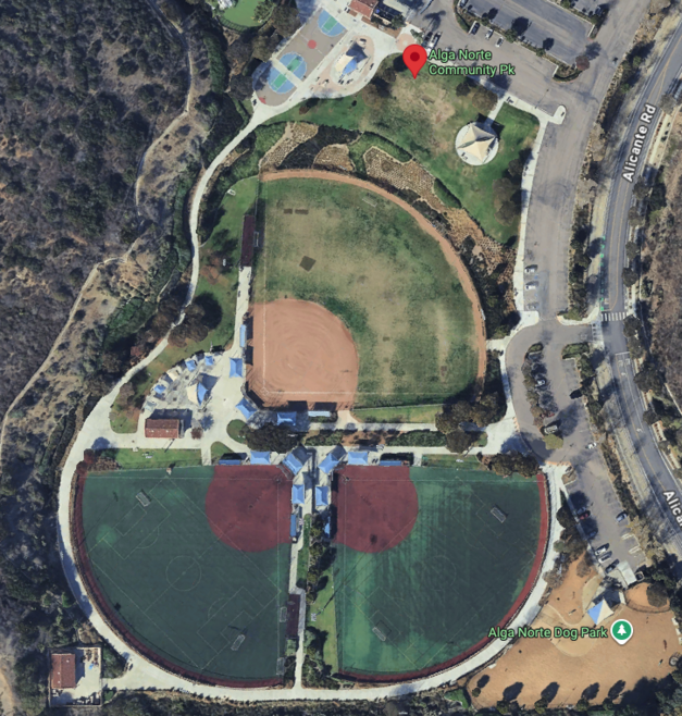 Aerial view of a baseball/softball complex with multiple fields, parking lots, and surrounding roads.