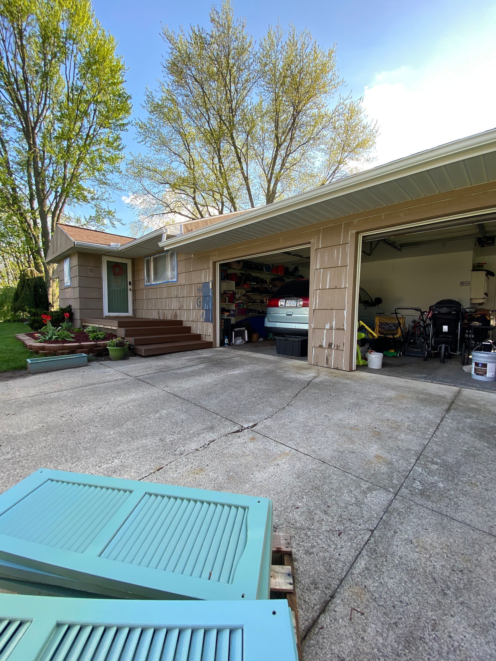 A house with a garage and a car parked in it.
