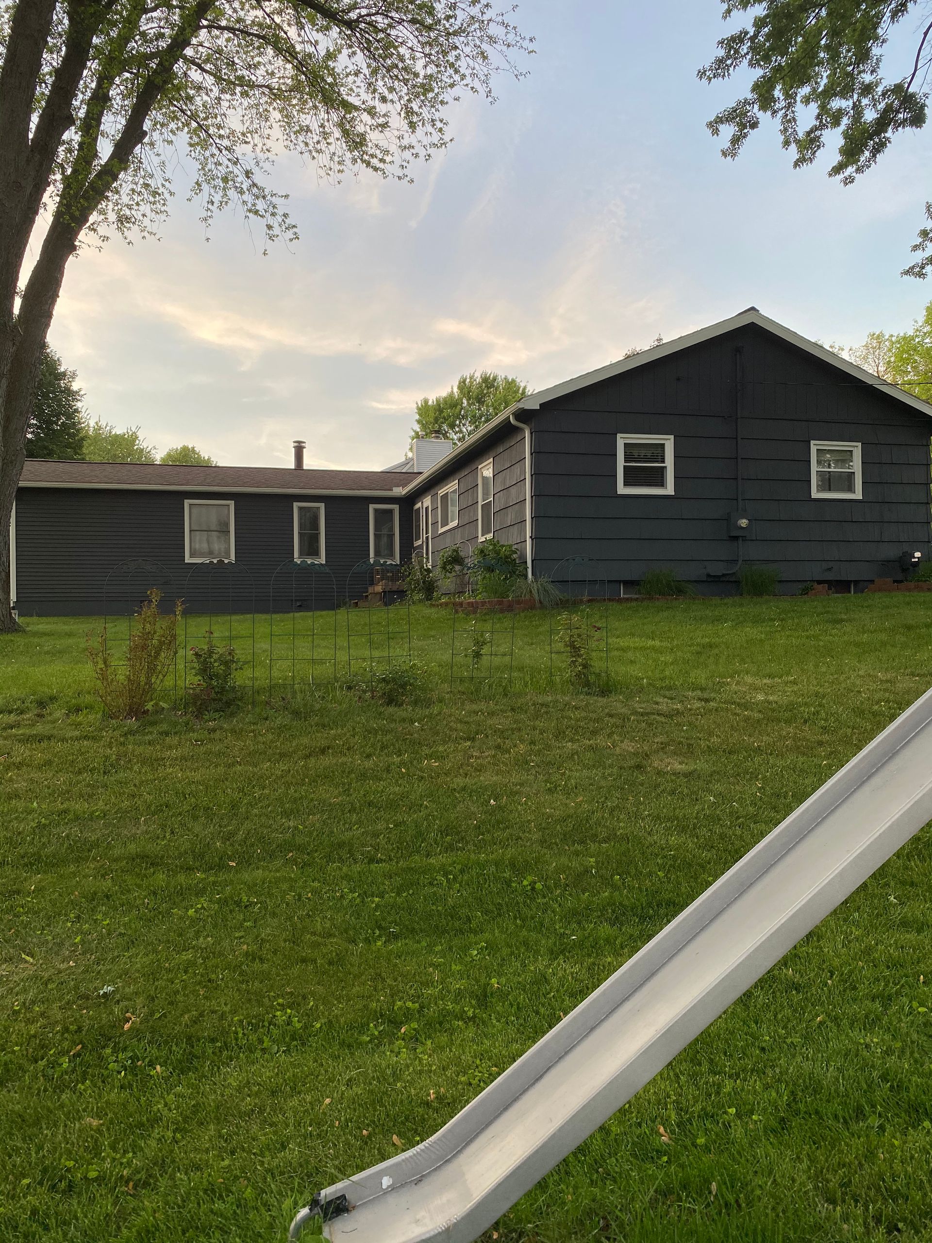 A house with a slide in front of it