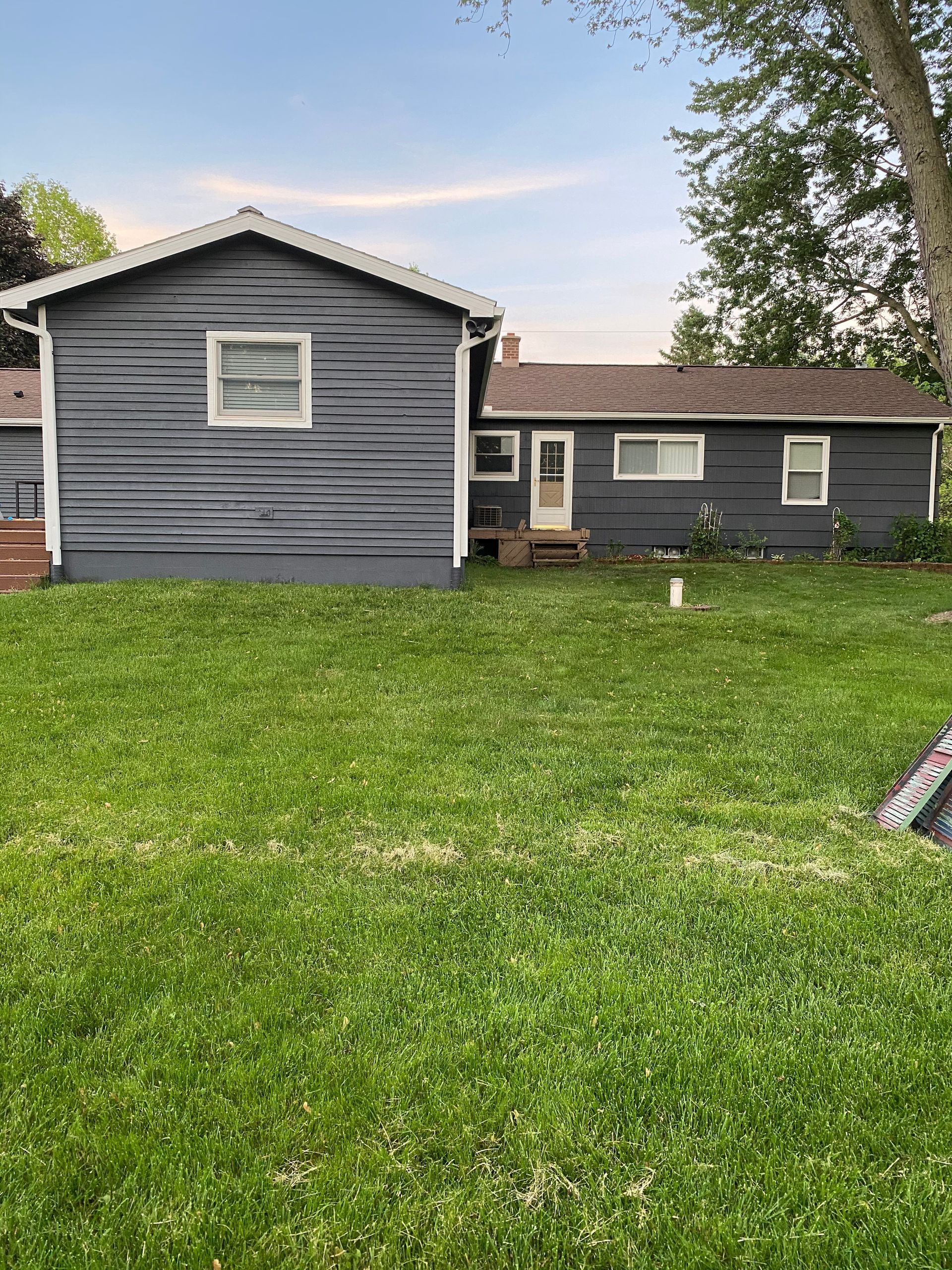 A house with a lot of grass in front of it.