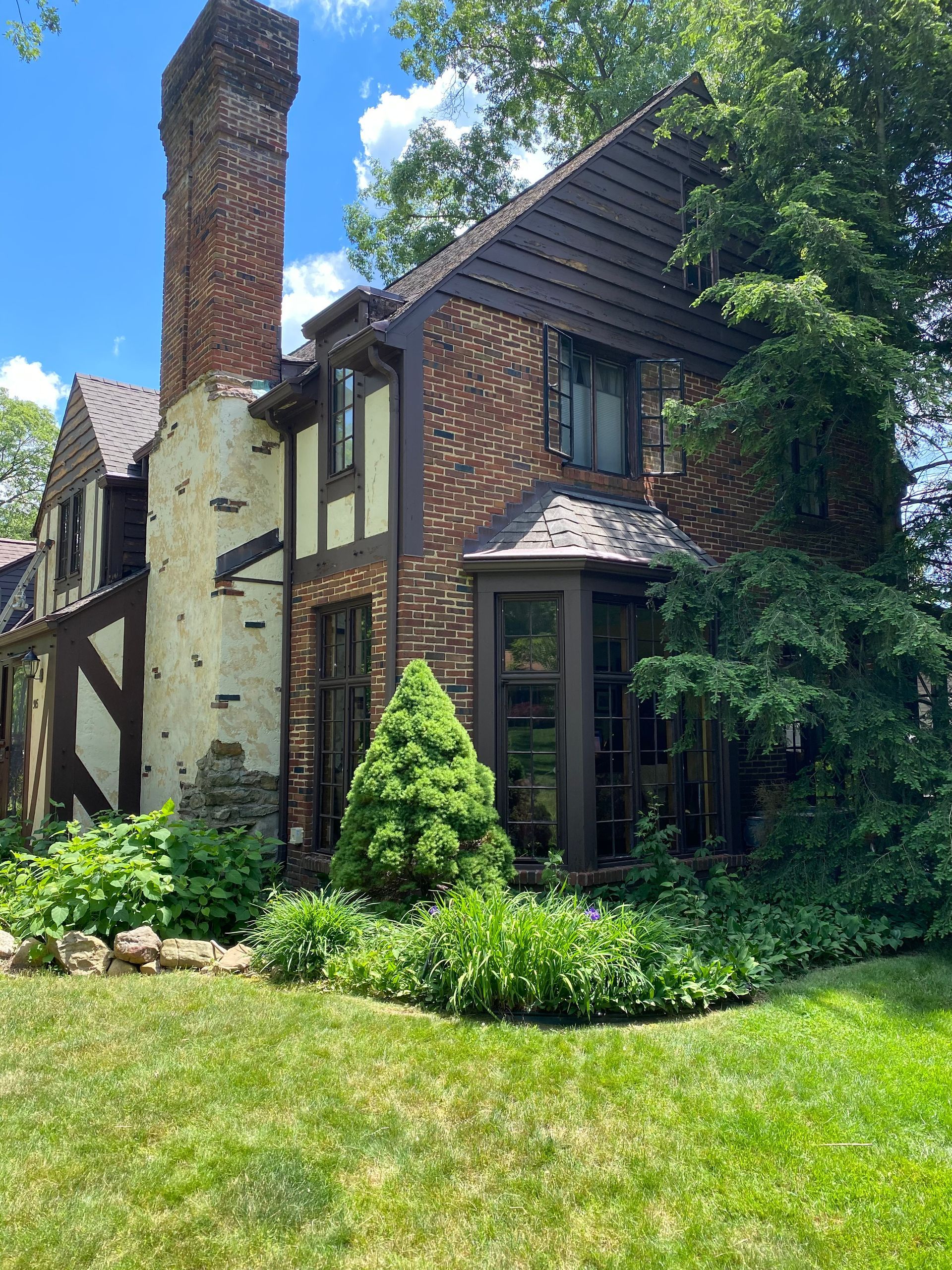 A large brick house with a chimney on top of it