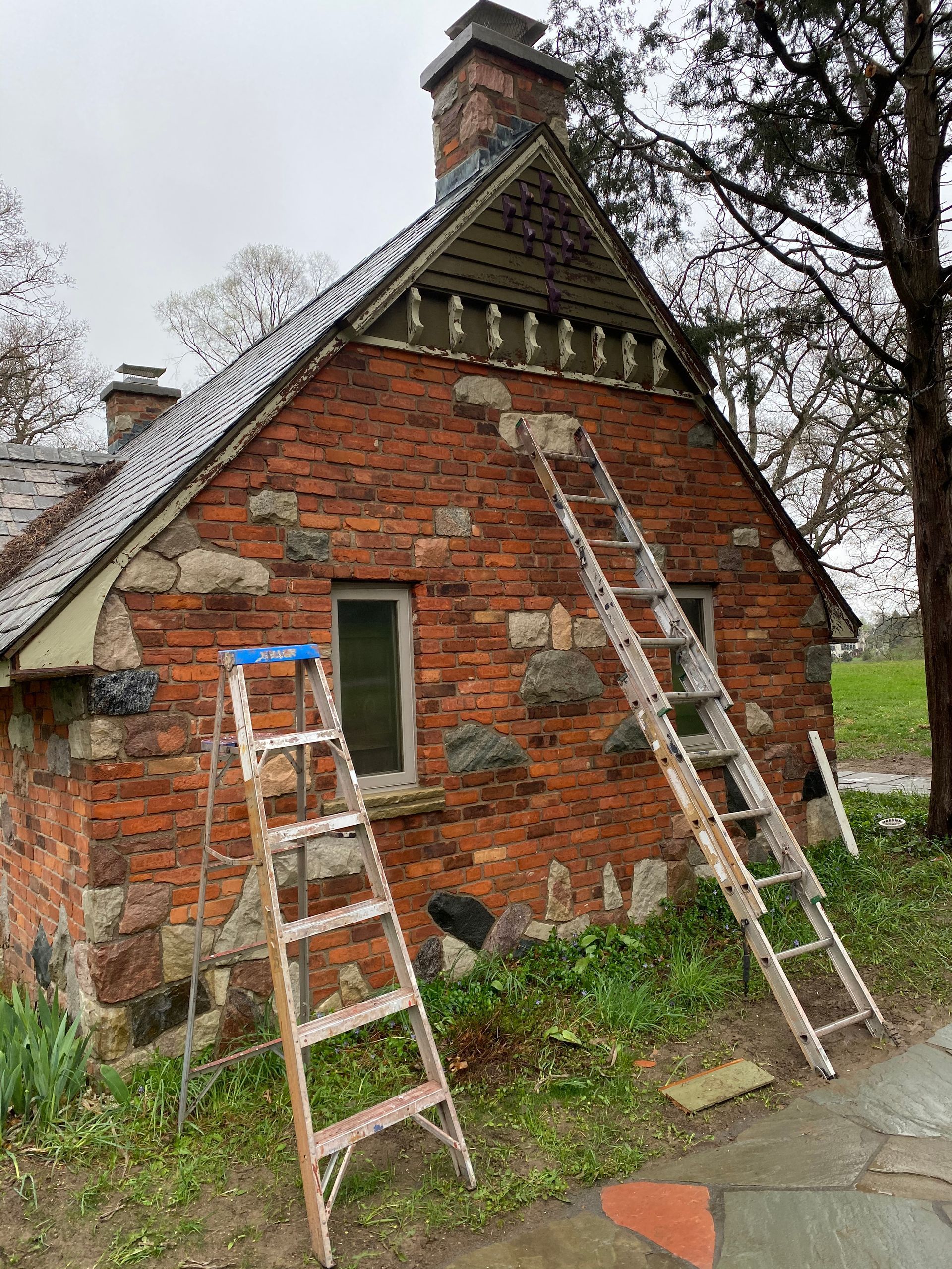 A ladder is leaning against a brick building.