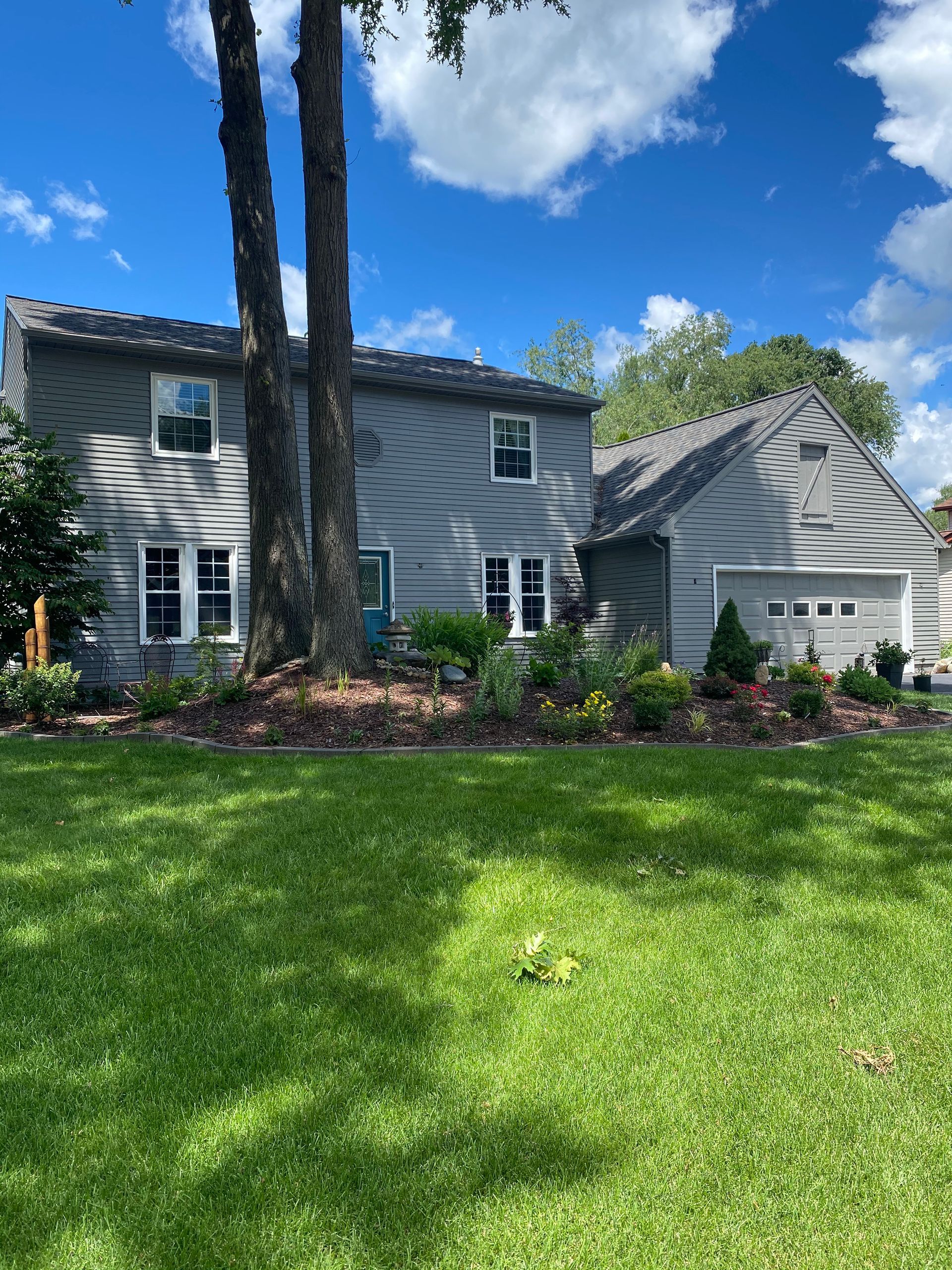 A large house with a lush green lawn in front of it.