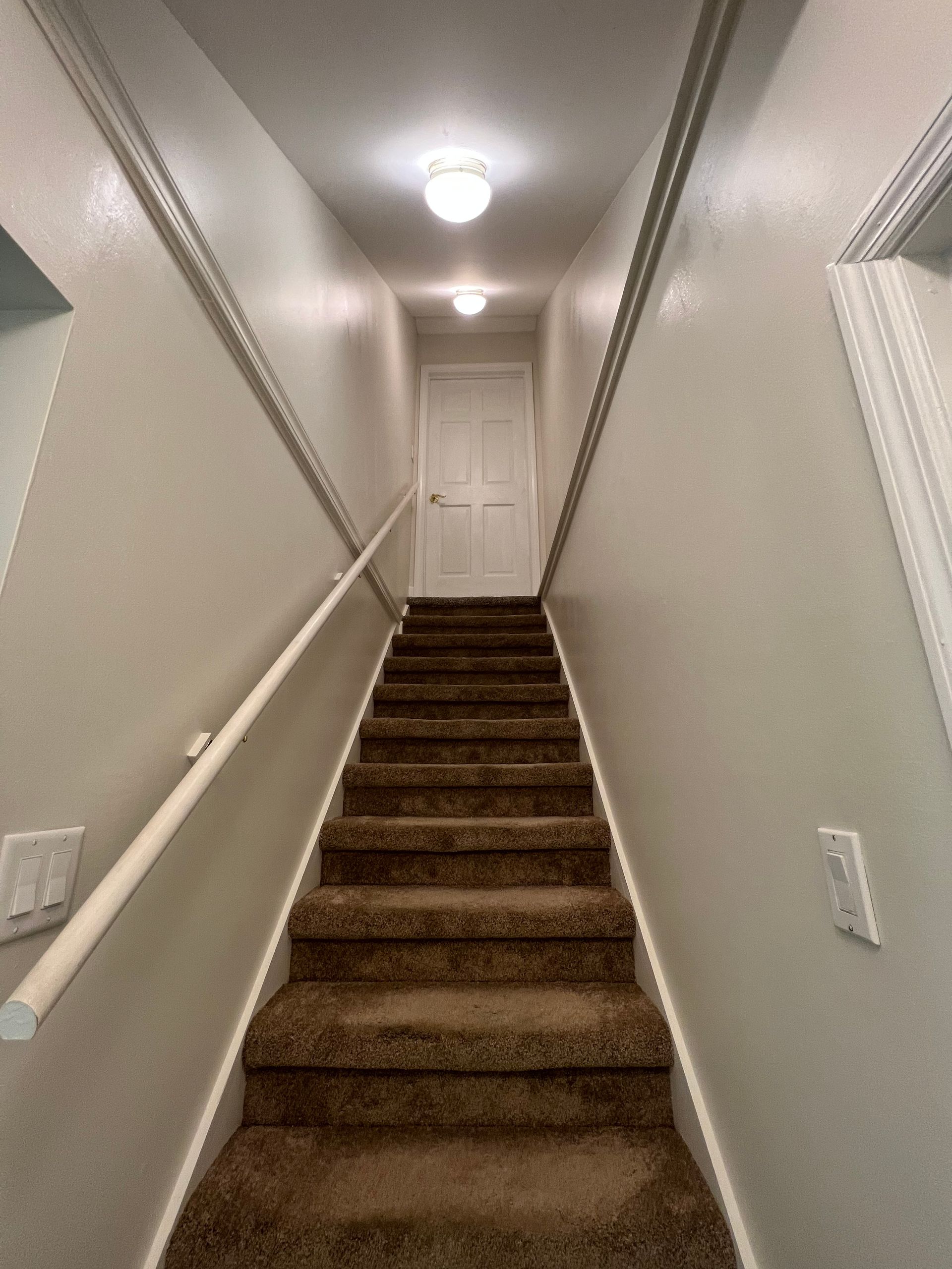 A set of stairs leading up to a door in a house.