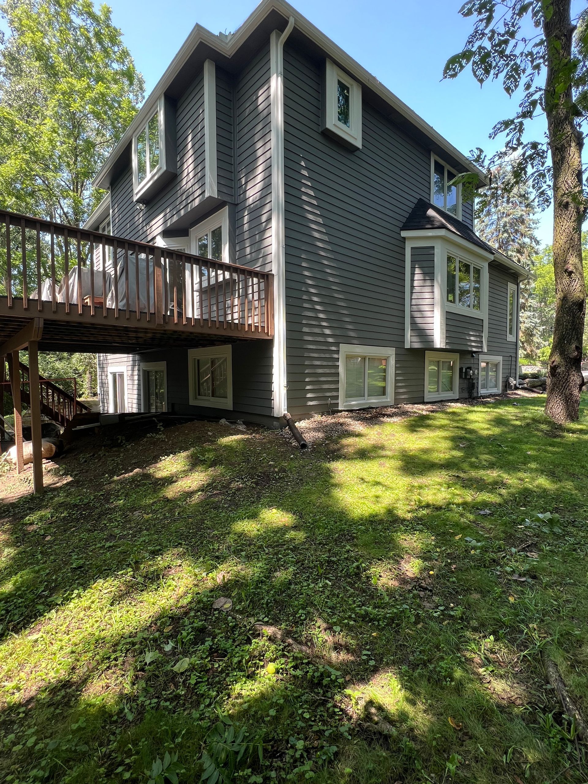 A large house with a deck and a lot of windows