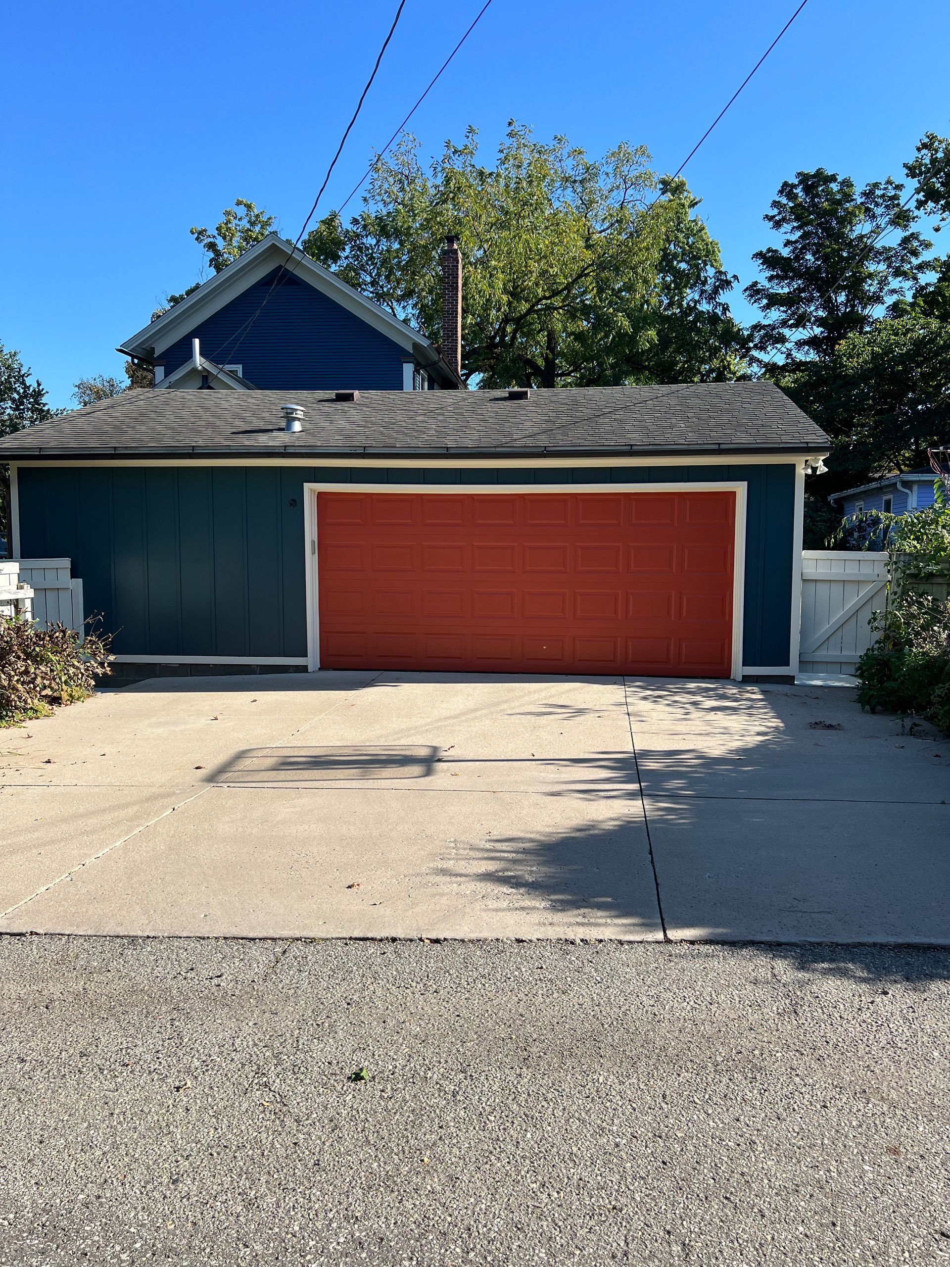 A blue house with a red garage door