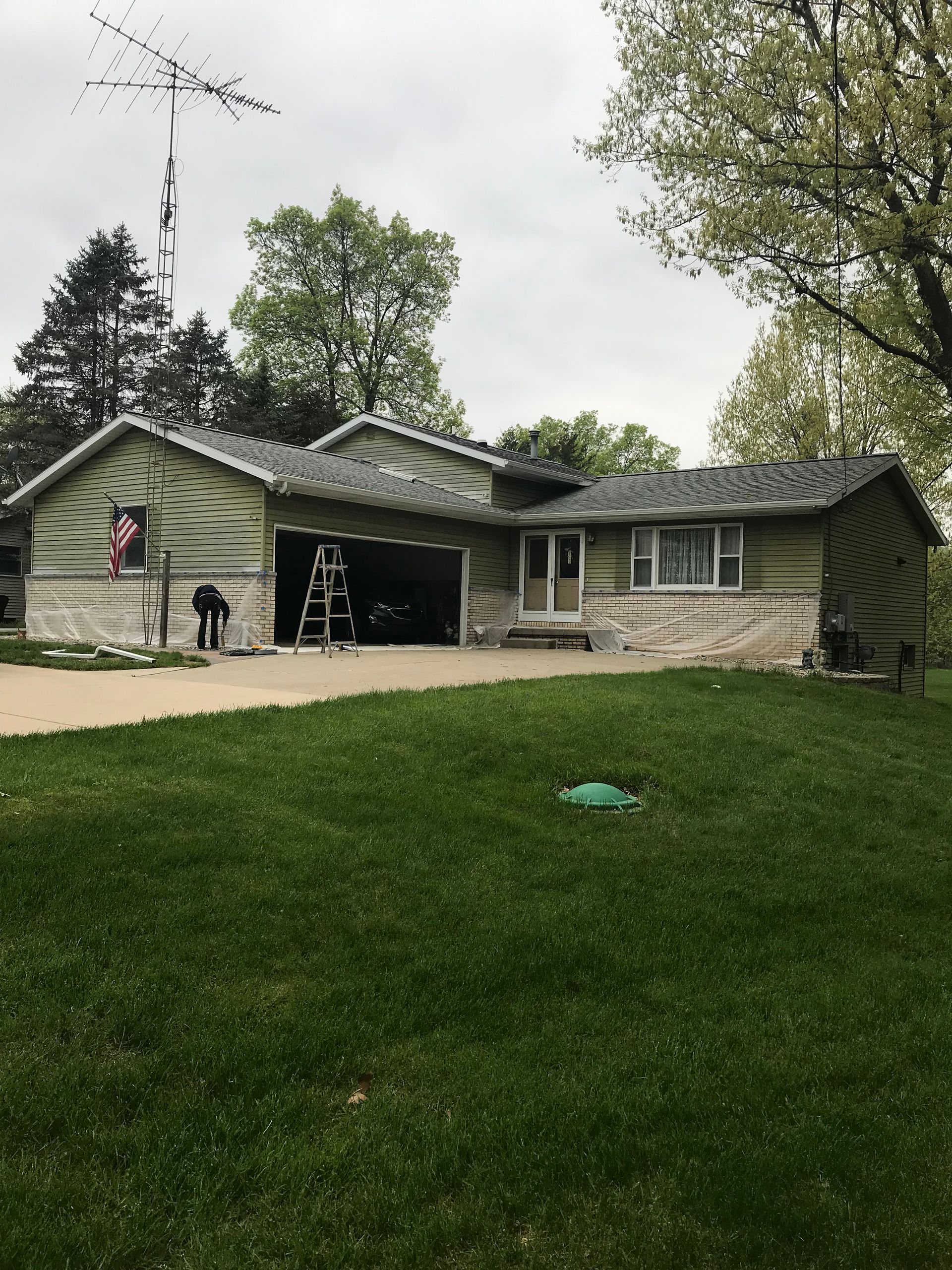 A house with a large lawn in front of it