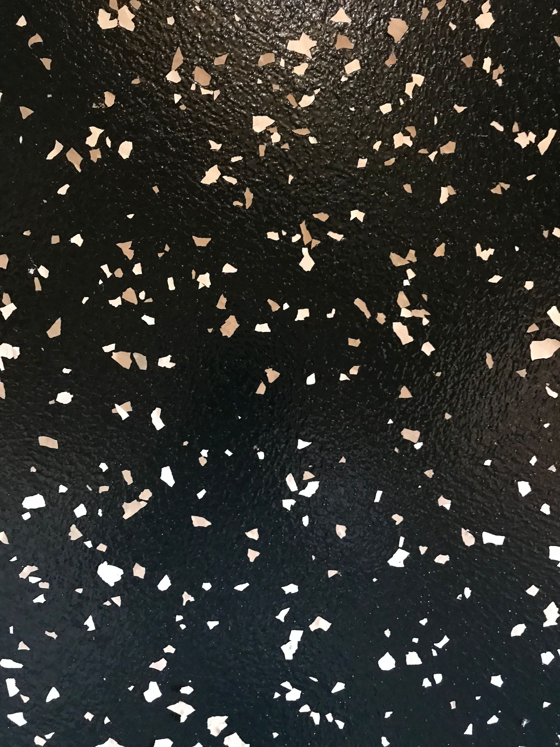 A black surface with white spots on it