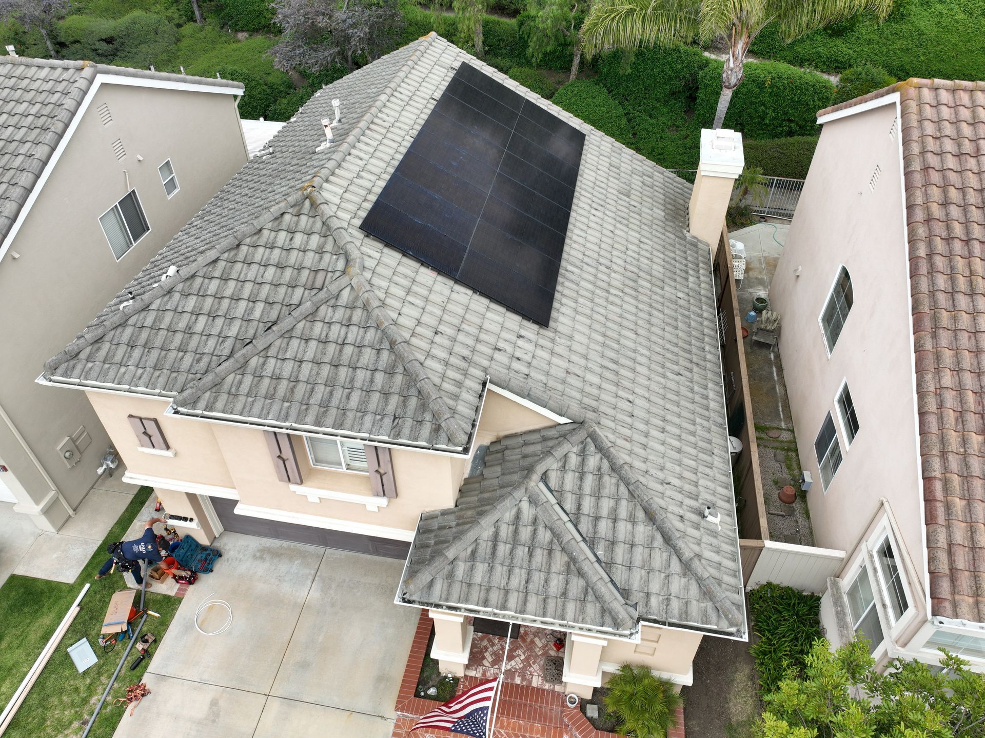 Solar panels installed on a residential roof under a blue sky.