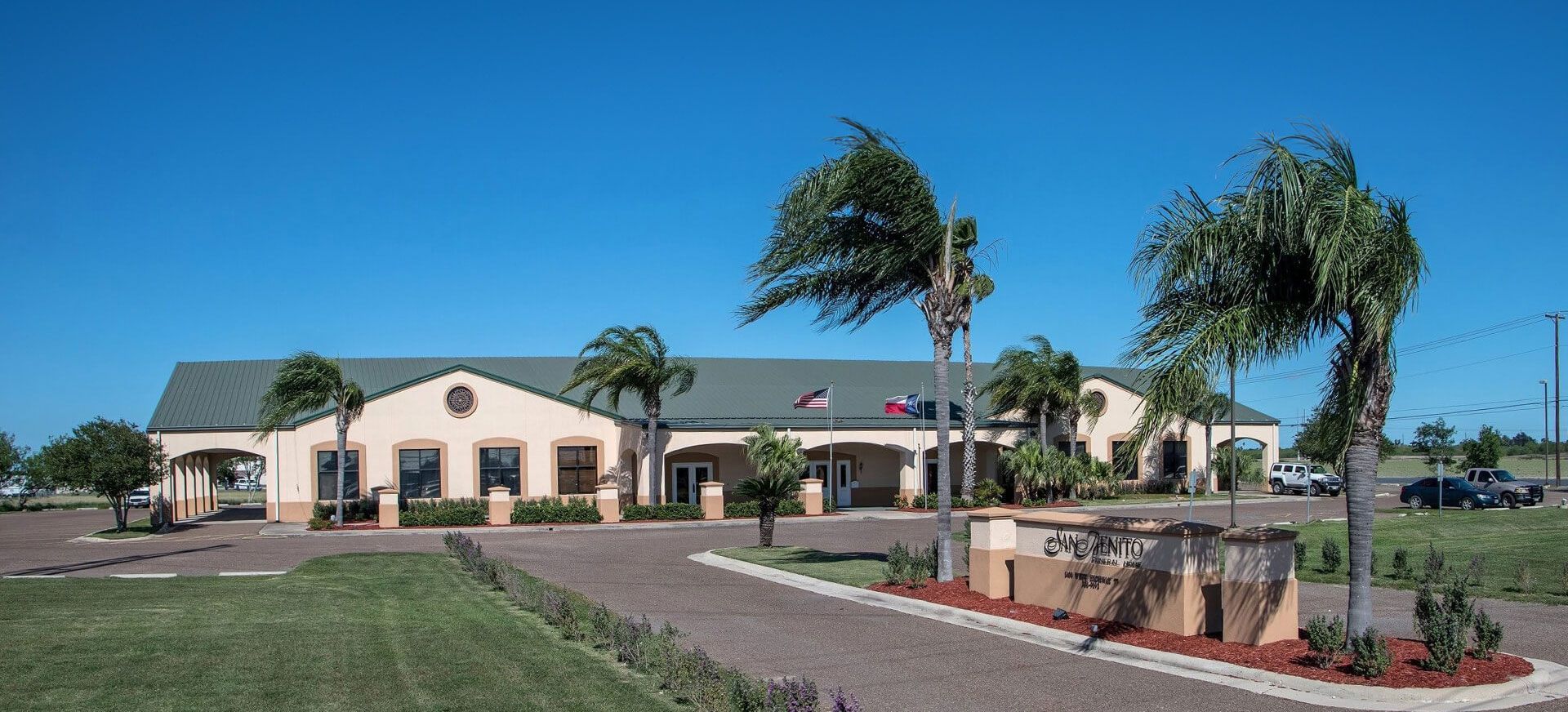 A large building with palm trees in front of it