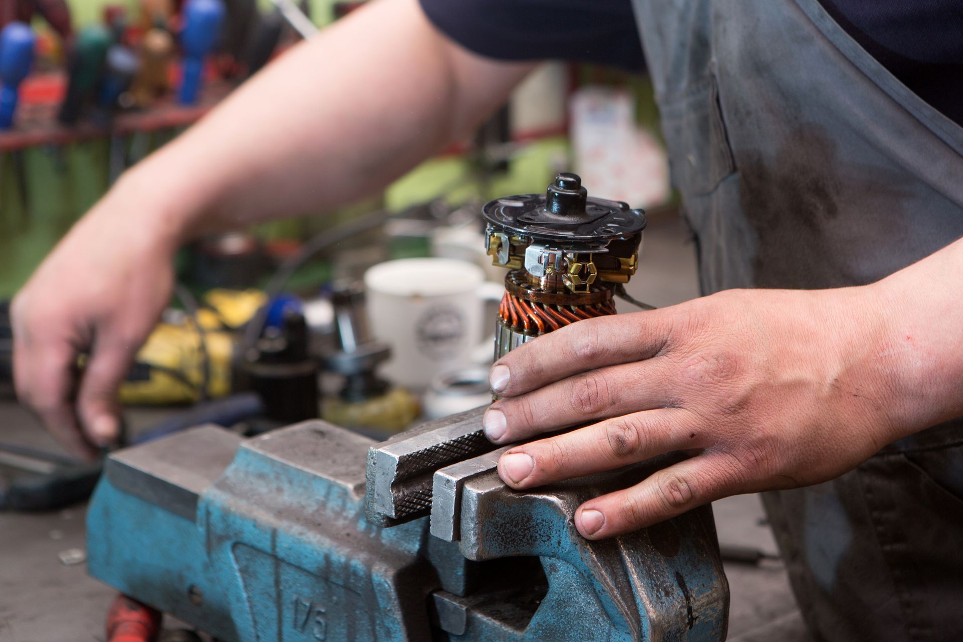 Mechanic repairing an electric motor at a repair shop Mechanic repairing an electric motor at a repair shop
