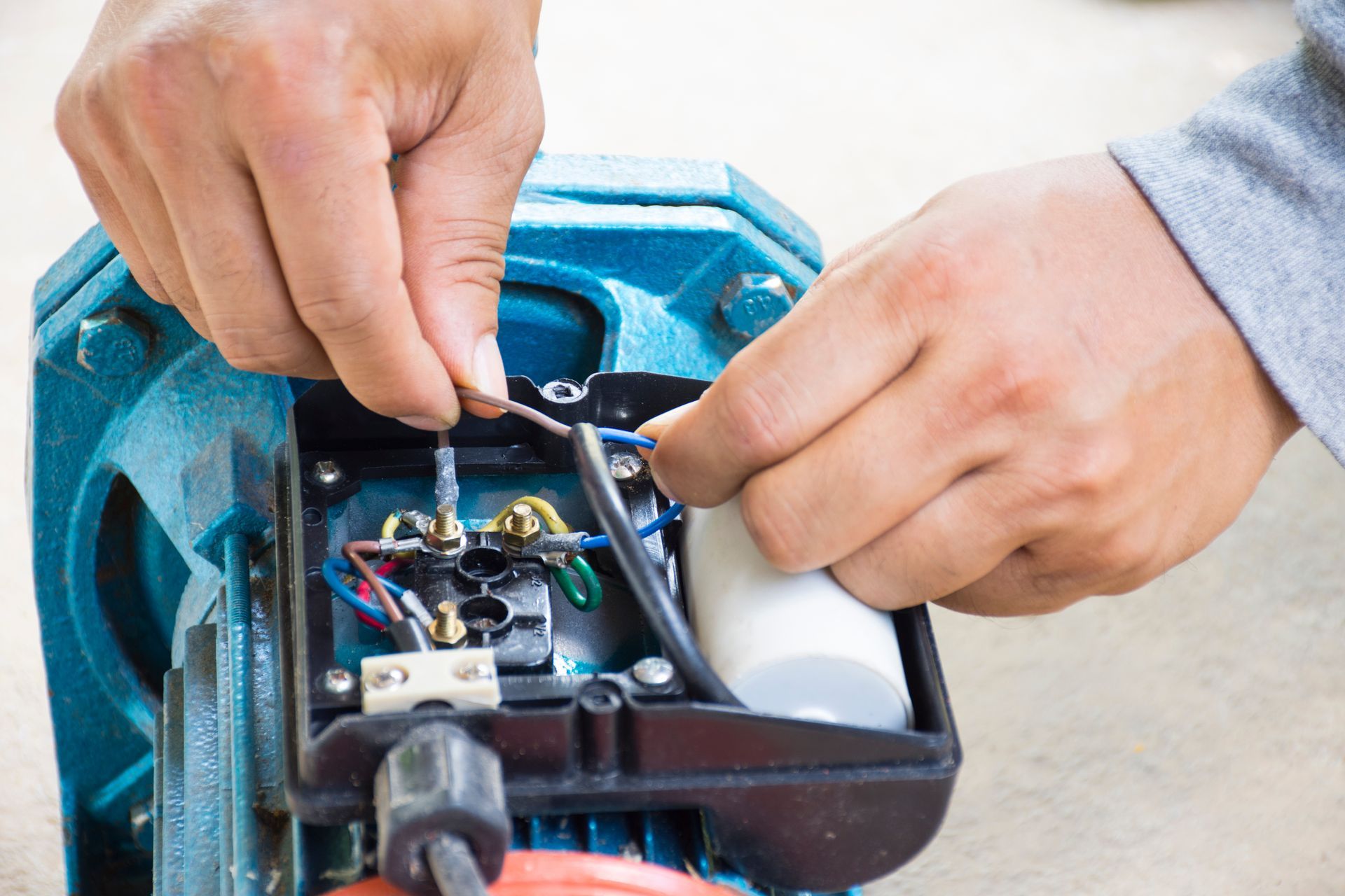 Electric motor repair technician working on electric motor