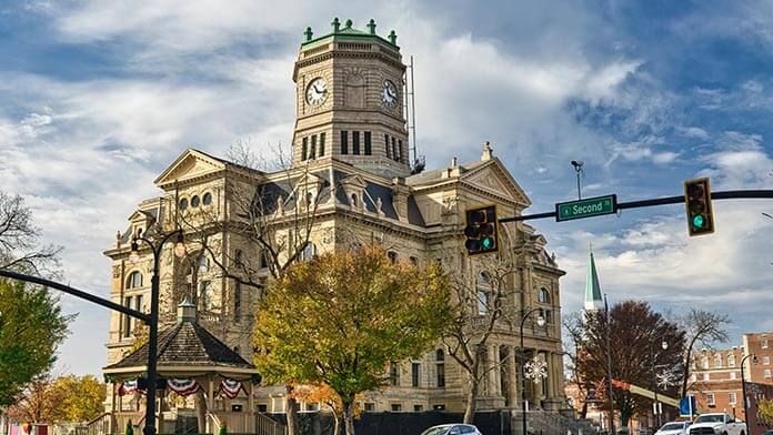 Historic courthouse with clock tower under a cloudy sky.
