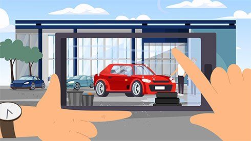 Hands framing a smartphone screen showing a red car in a modern showroom