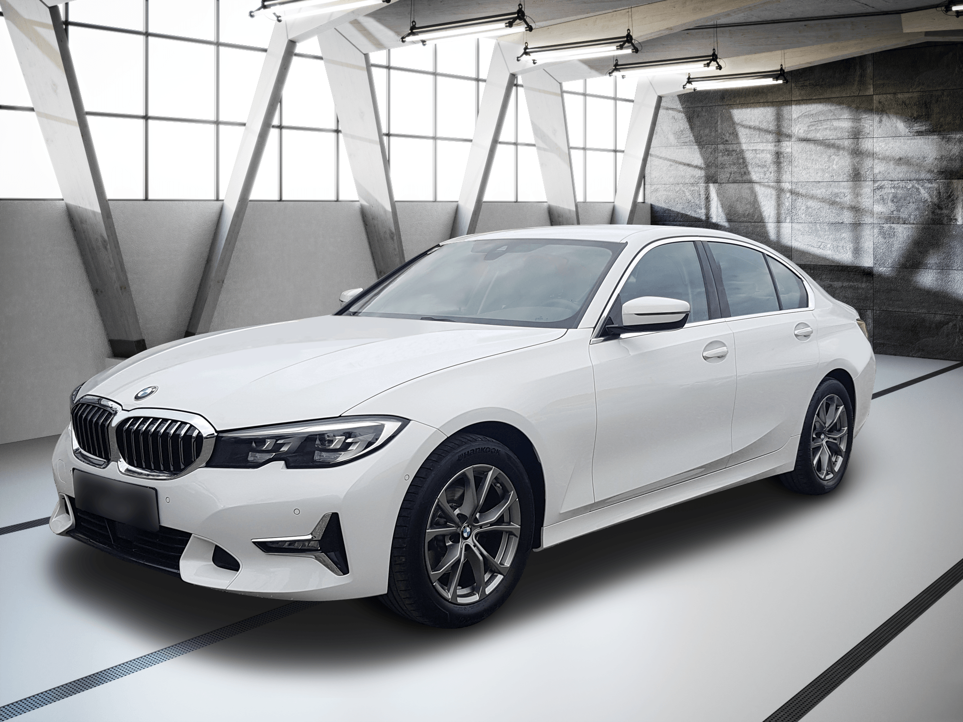 White BMW sedan parked in a bright modern showroom