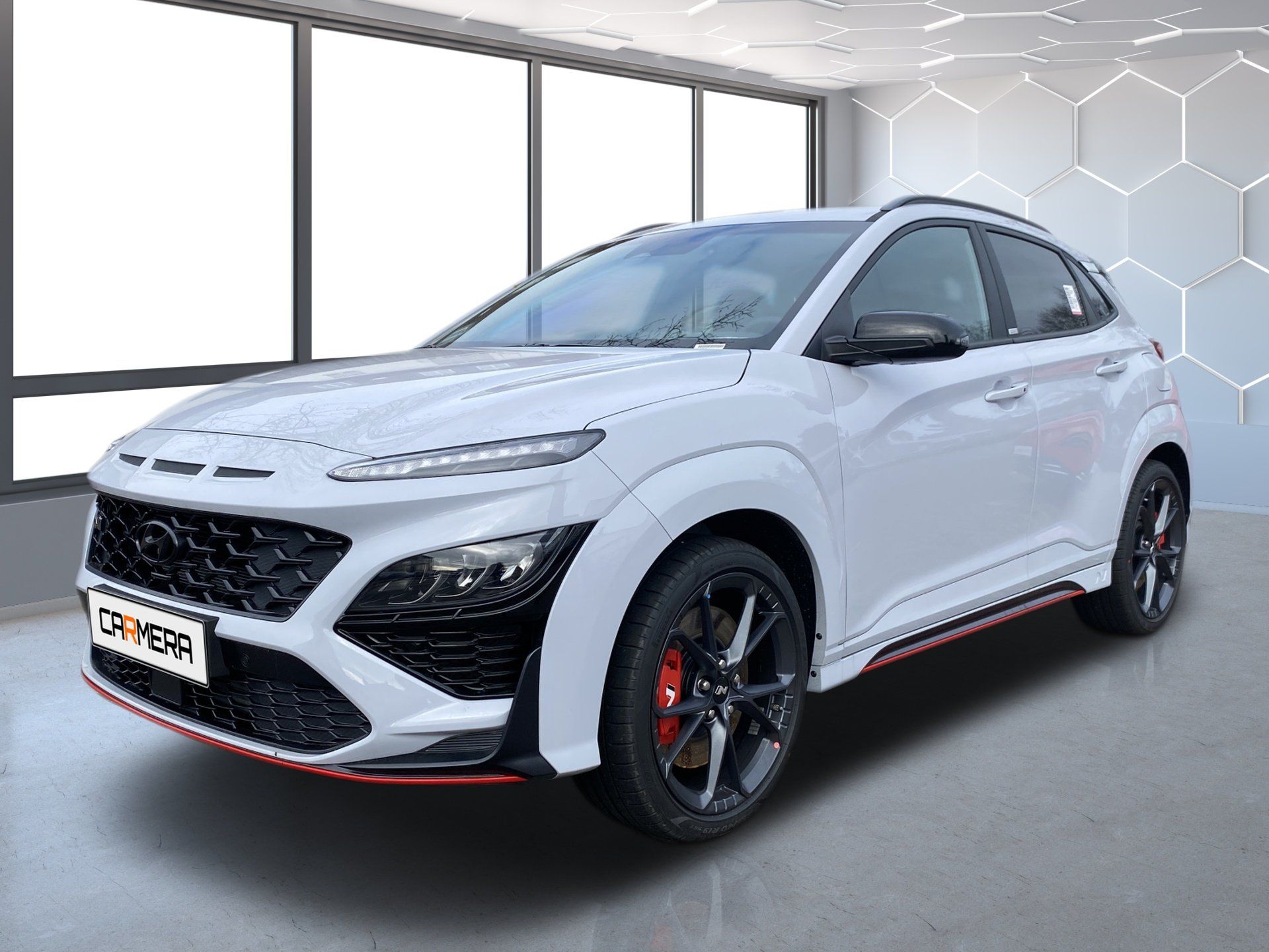 White sporty SUV with red accents in a bright showroom-like setting
