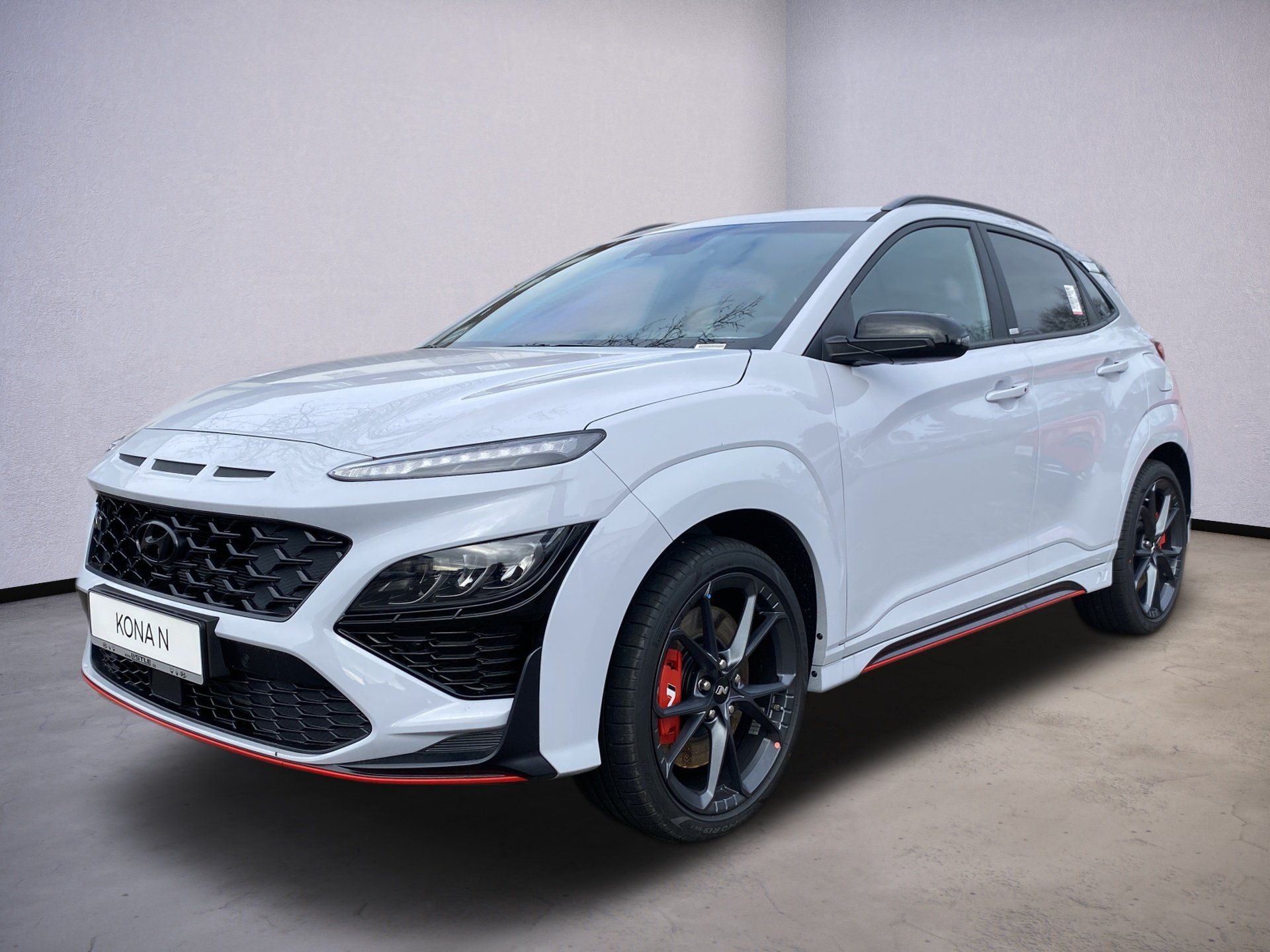 White sporty SUV with black trim and red accents, shown in a studio-style side front view.