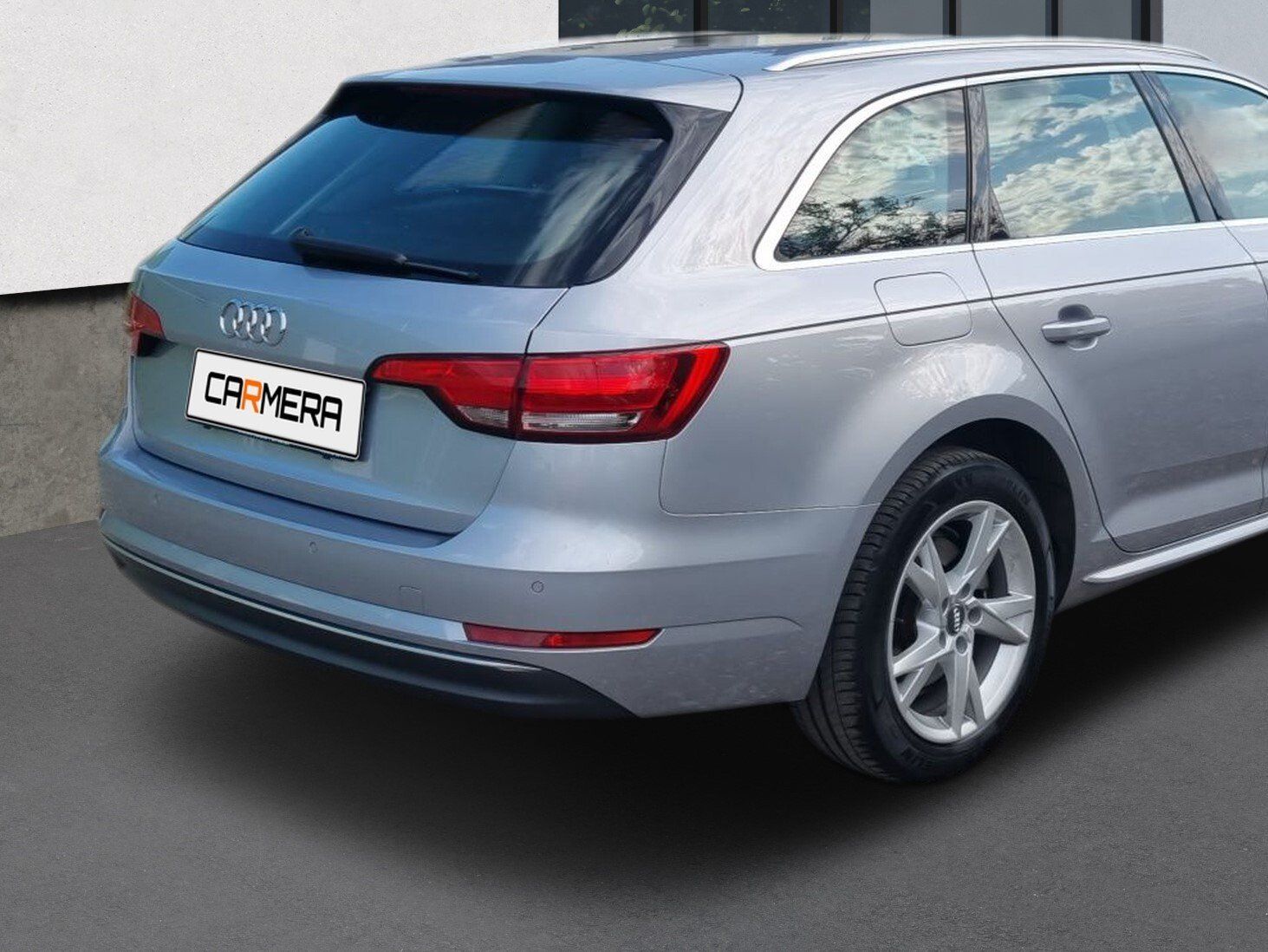 Silver Audi station wagon parked outdoors, rear-left view.