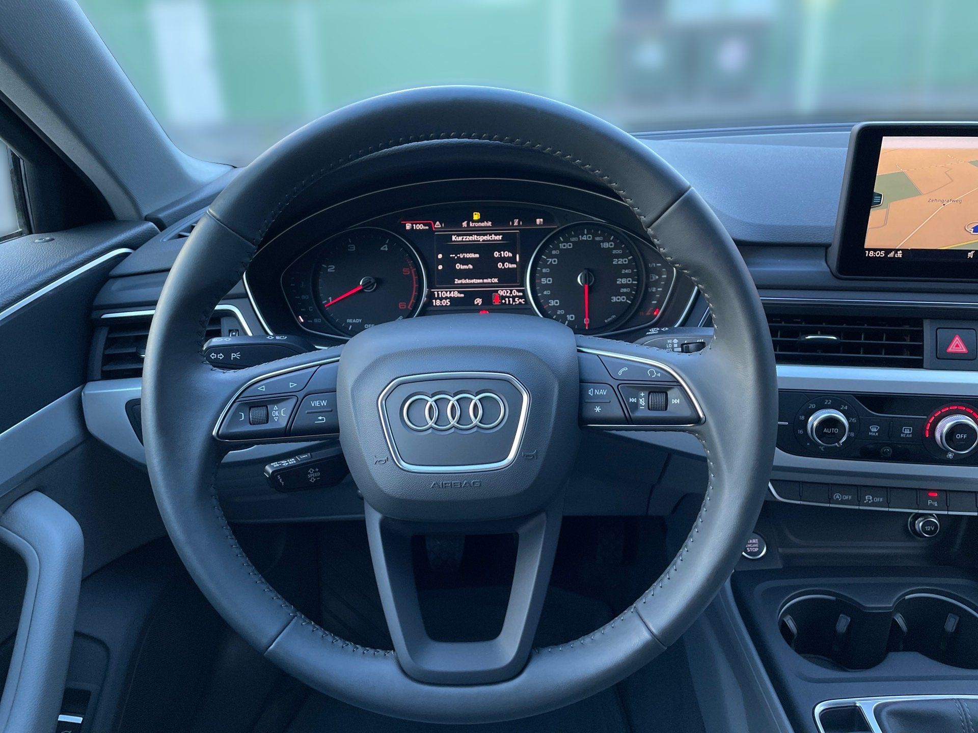 Audi car interior with steering wheel, digital dashboard, and center console display