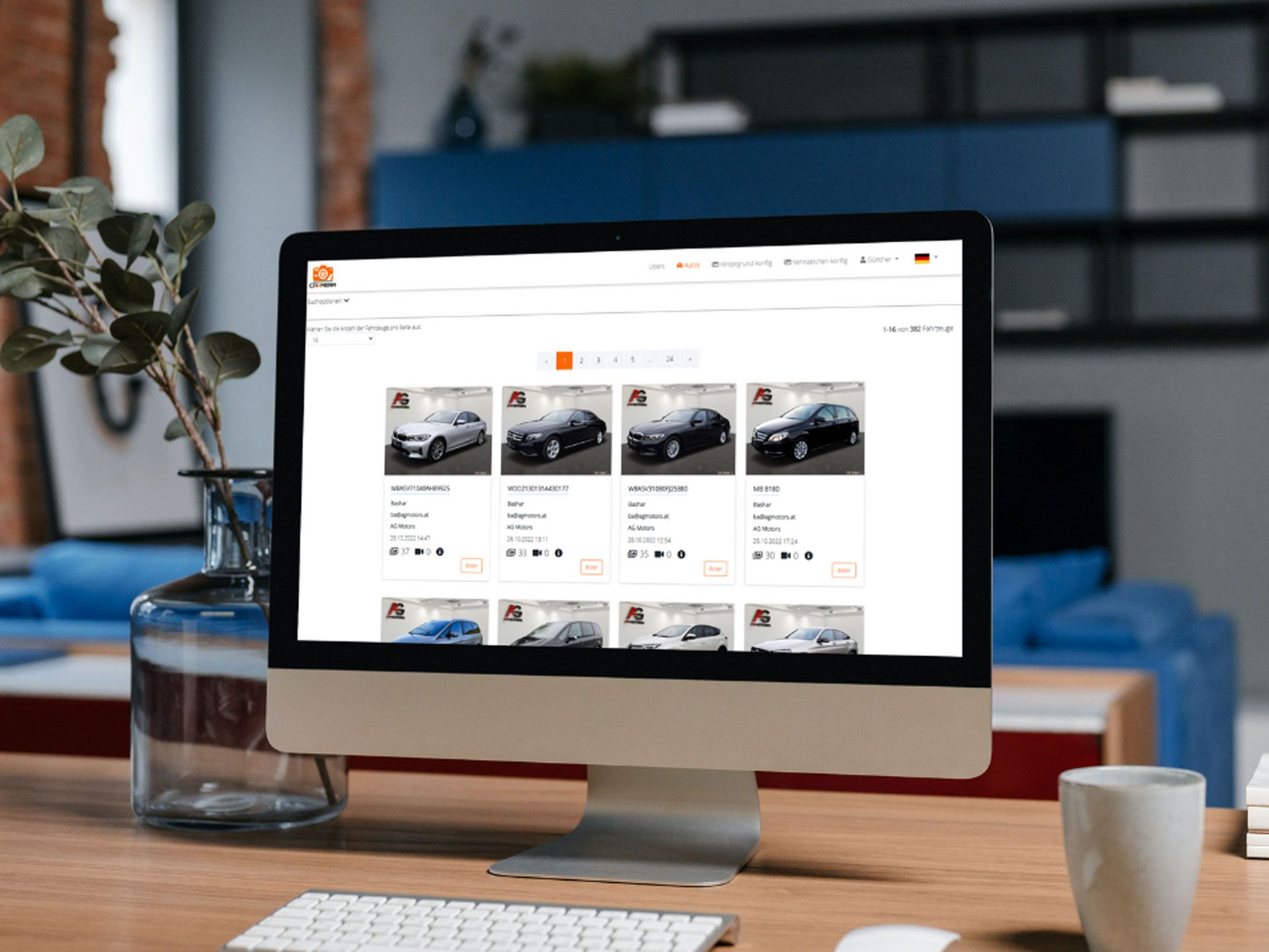 Desktop computer displaying a car marketplace website on a wooden desk in a bright room