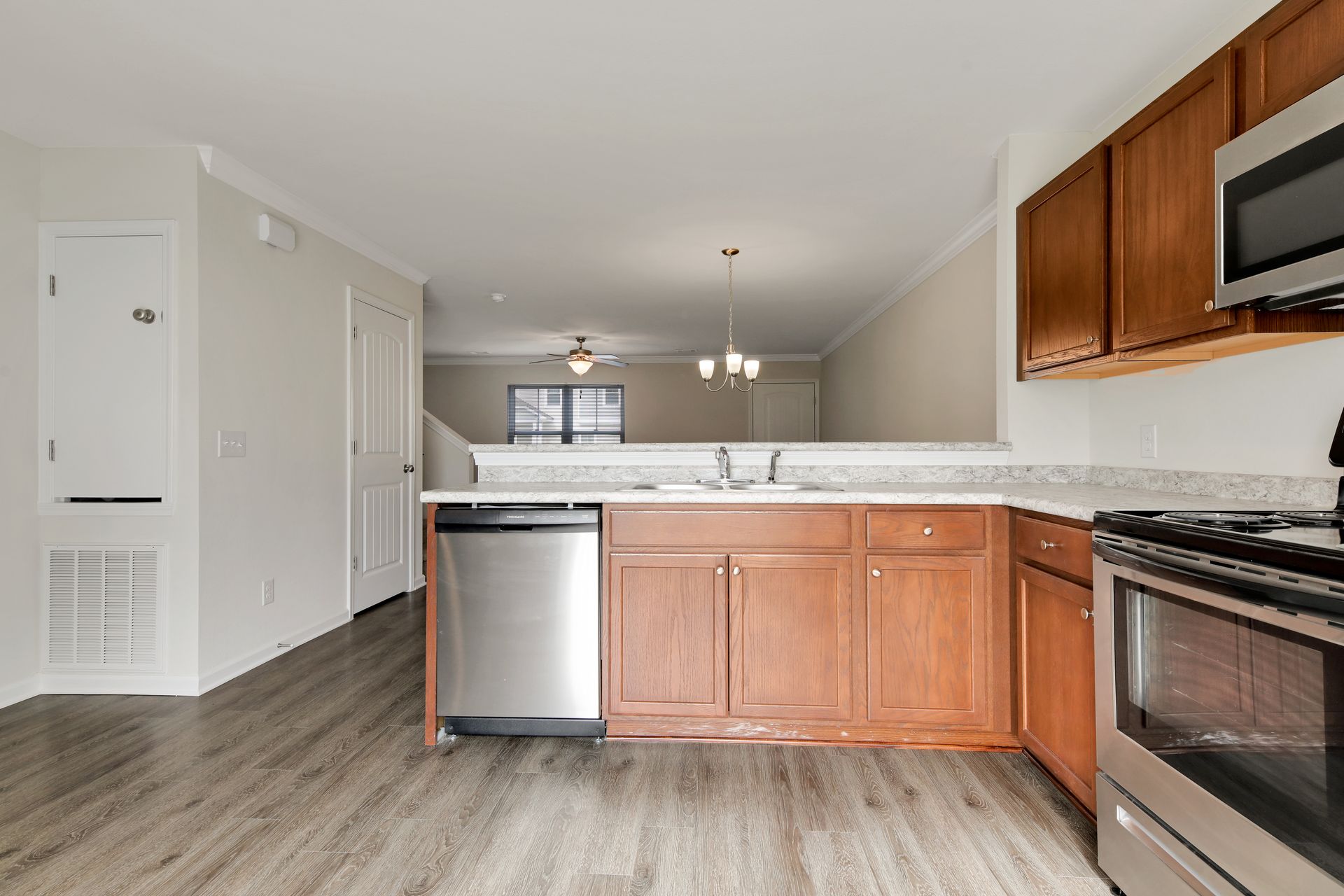 A kitchen with wooden cabinets and stainless steel appliances