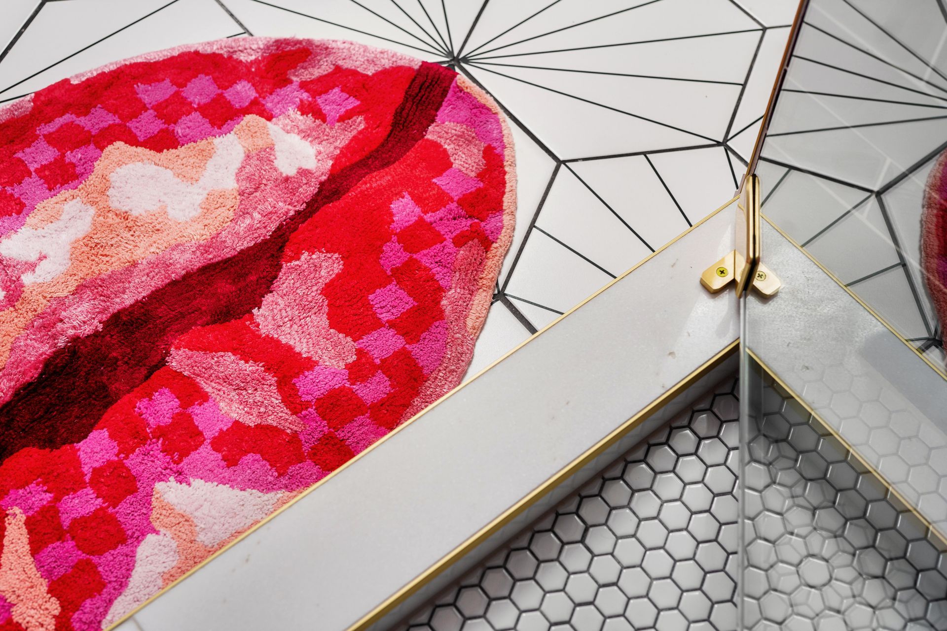 Abstract geometric pattern with pink and red shapes on white and gray surfaces
