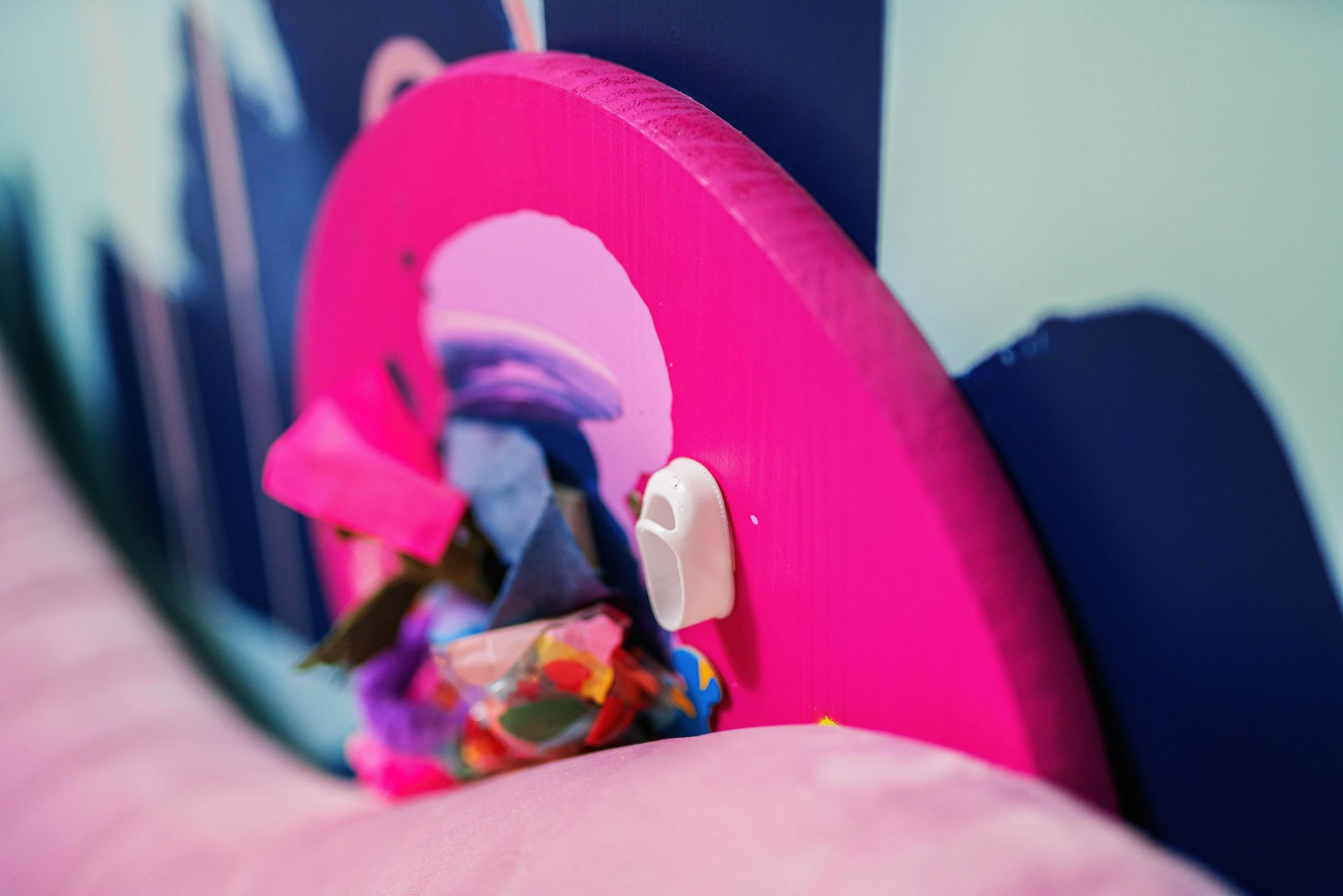 Pink toy playset with a small figurine inside a circular opening