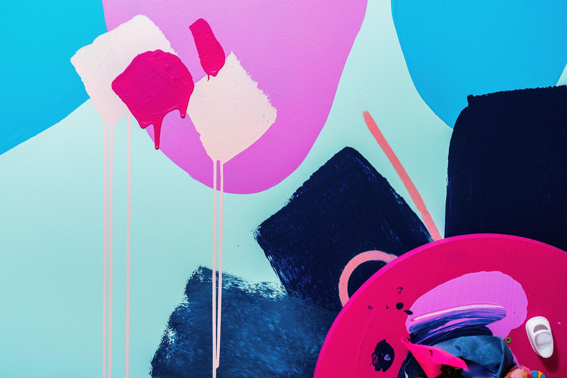 Abstract mural with pink and blue shapes, black brushstrokes, and a bright magenta circle