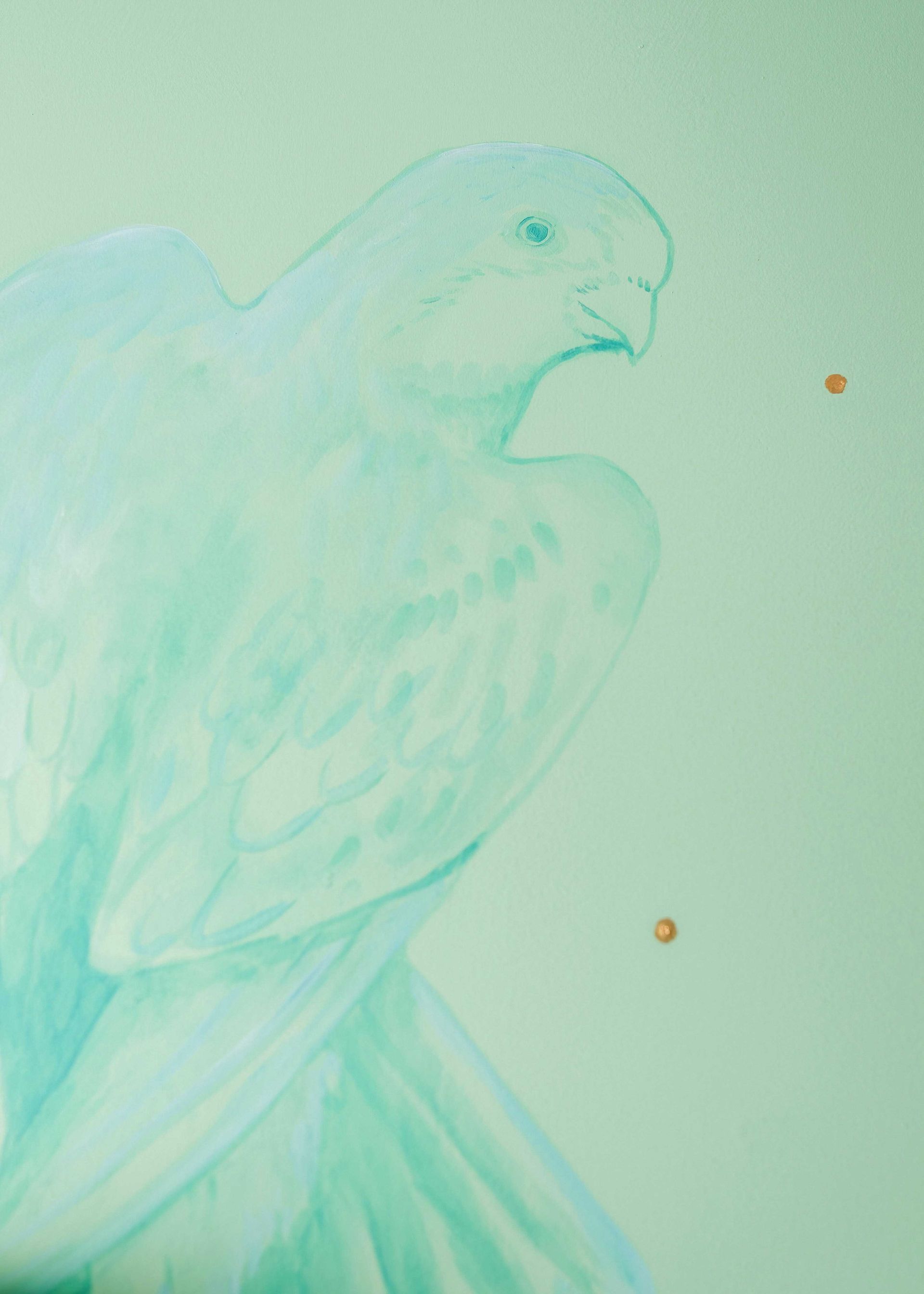 Pale teal bird in flight, side profile against a light background with two small orange dots