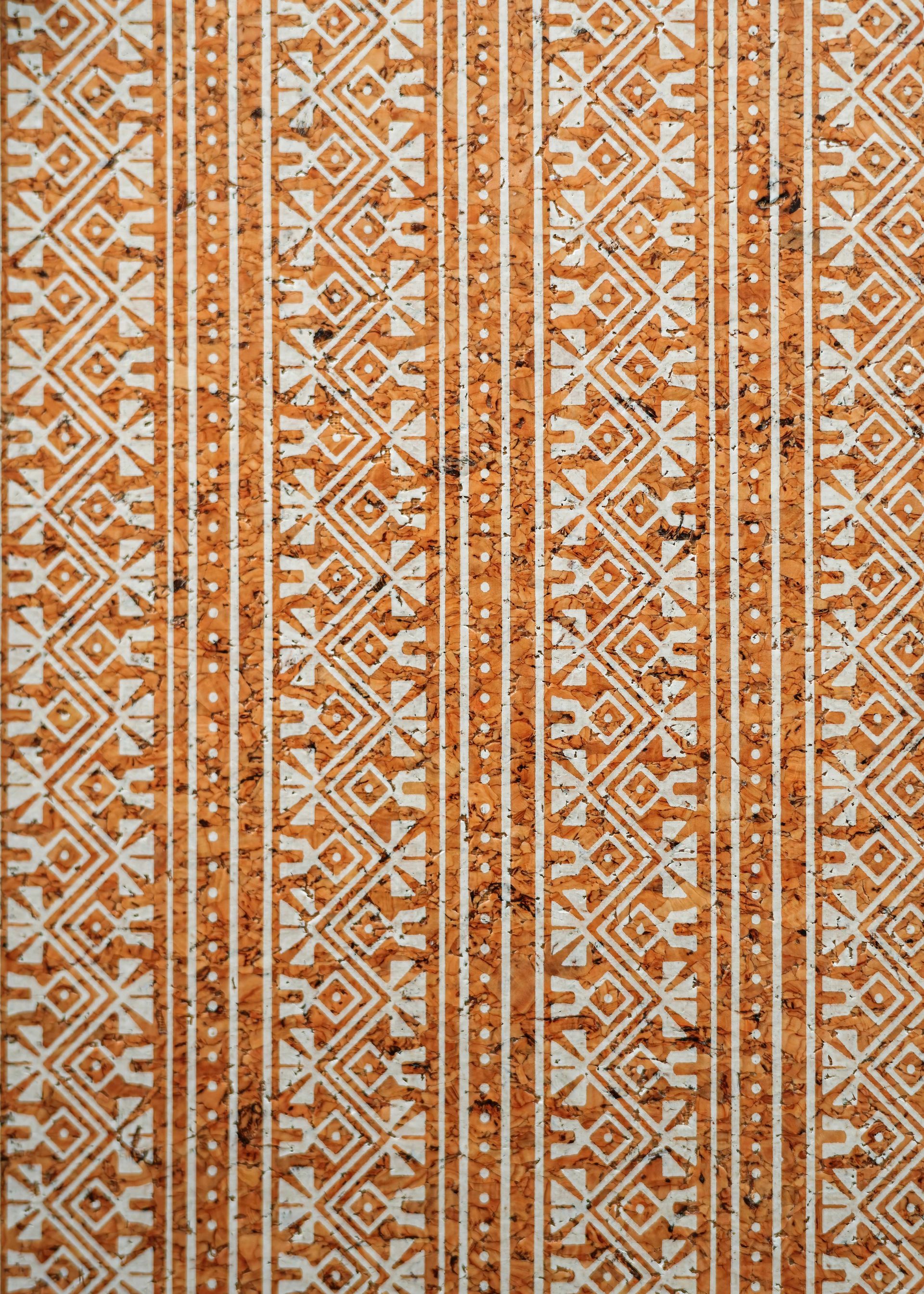 Orange and white geometric woven textile pattern with vertical stripes