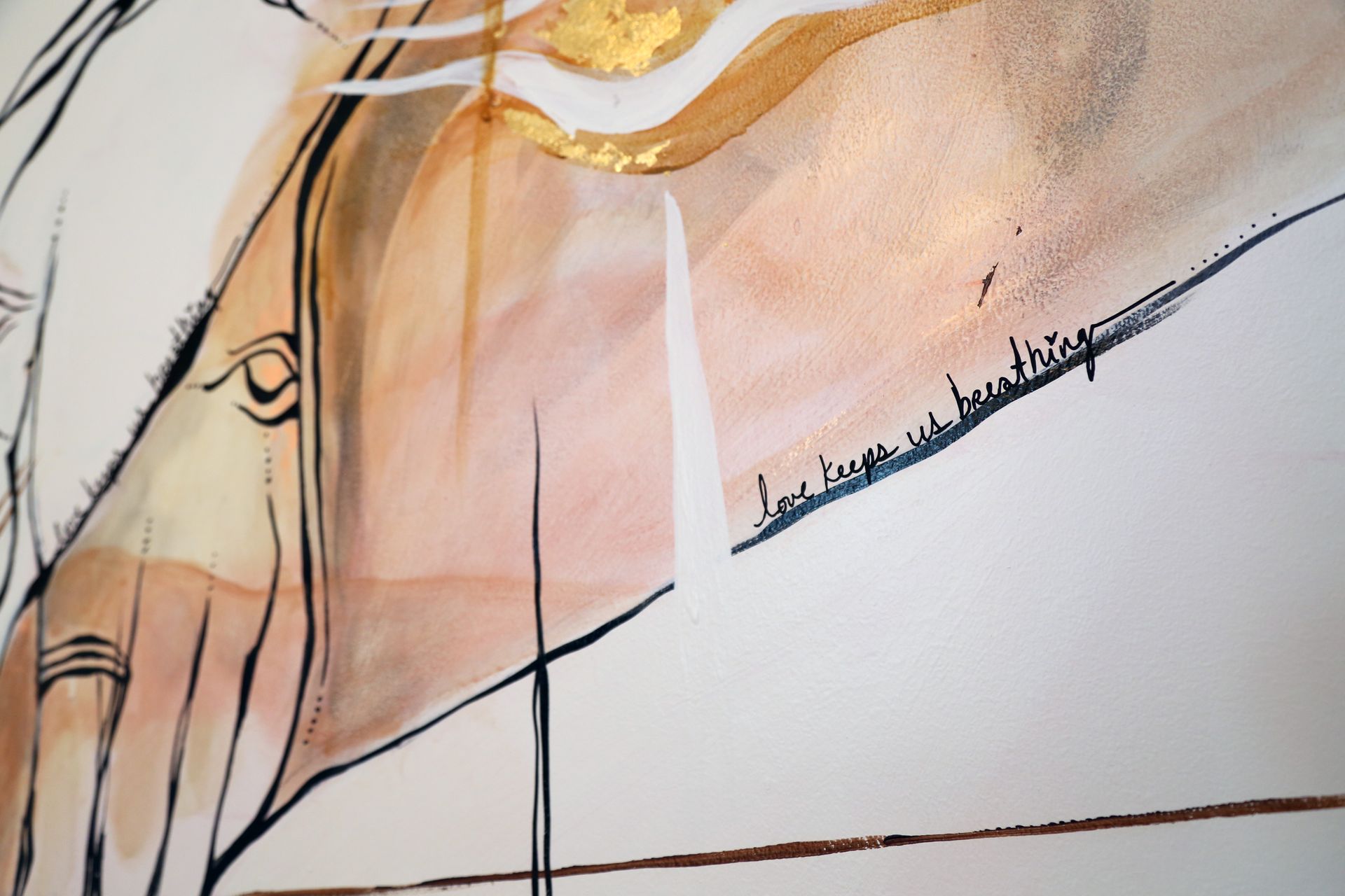Abstract line drawing on a warm peach background with black outlines and a gold brushstroke