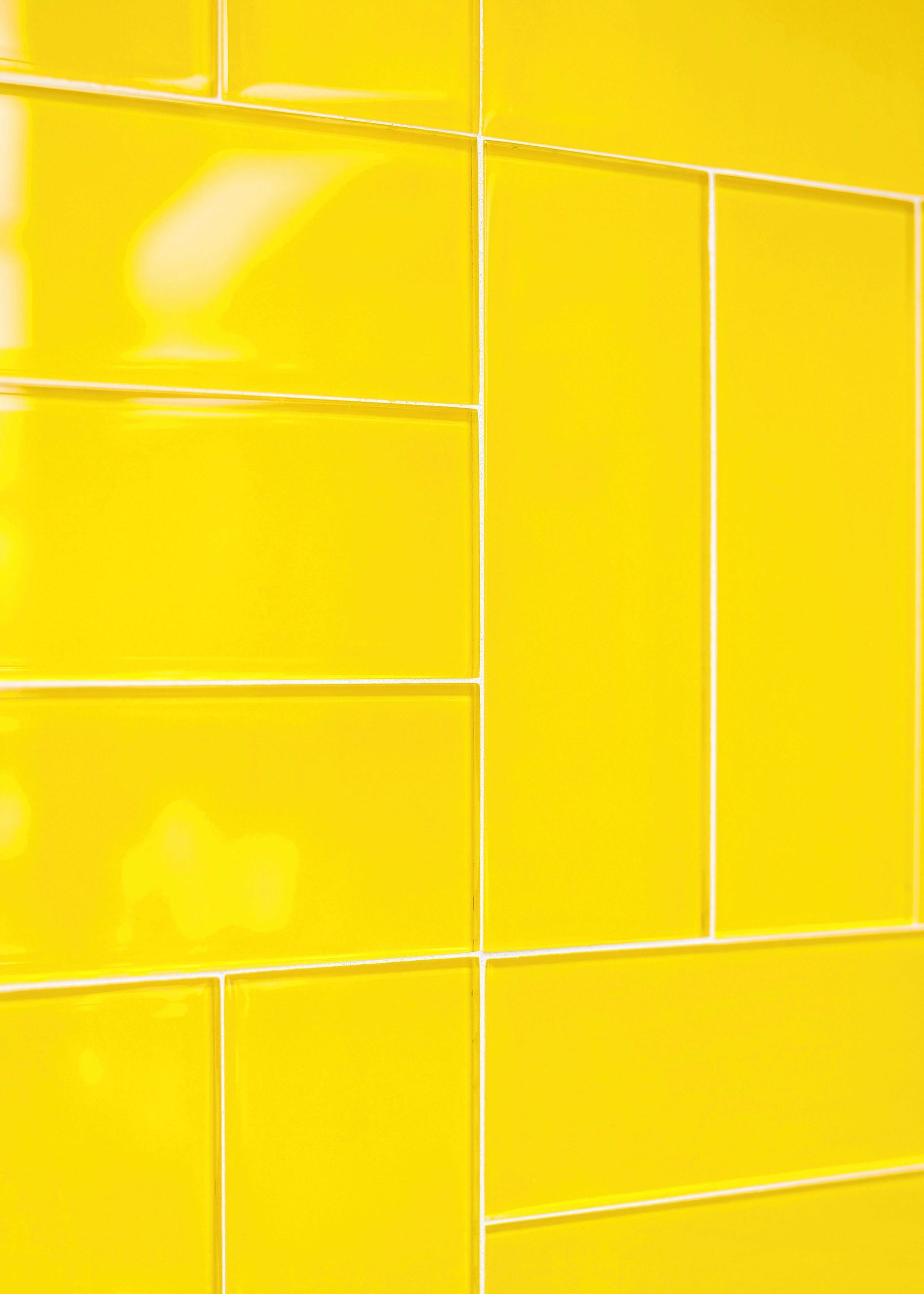 Yellow ceramic wall tiles with white grout lines