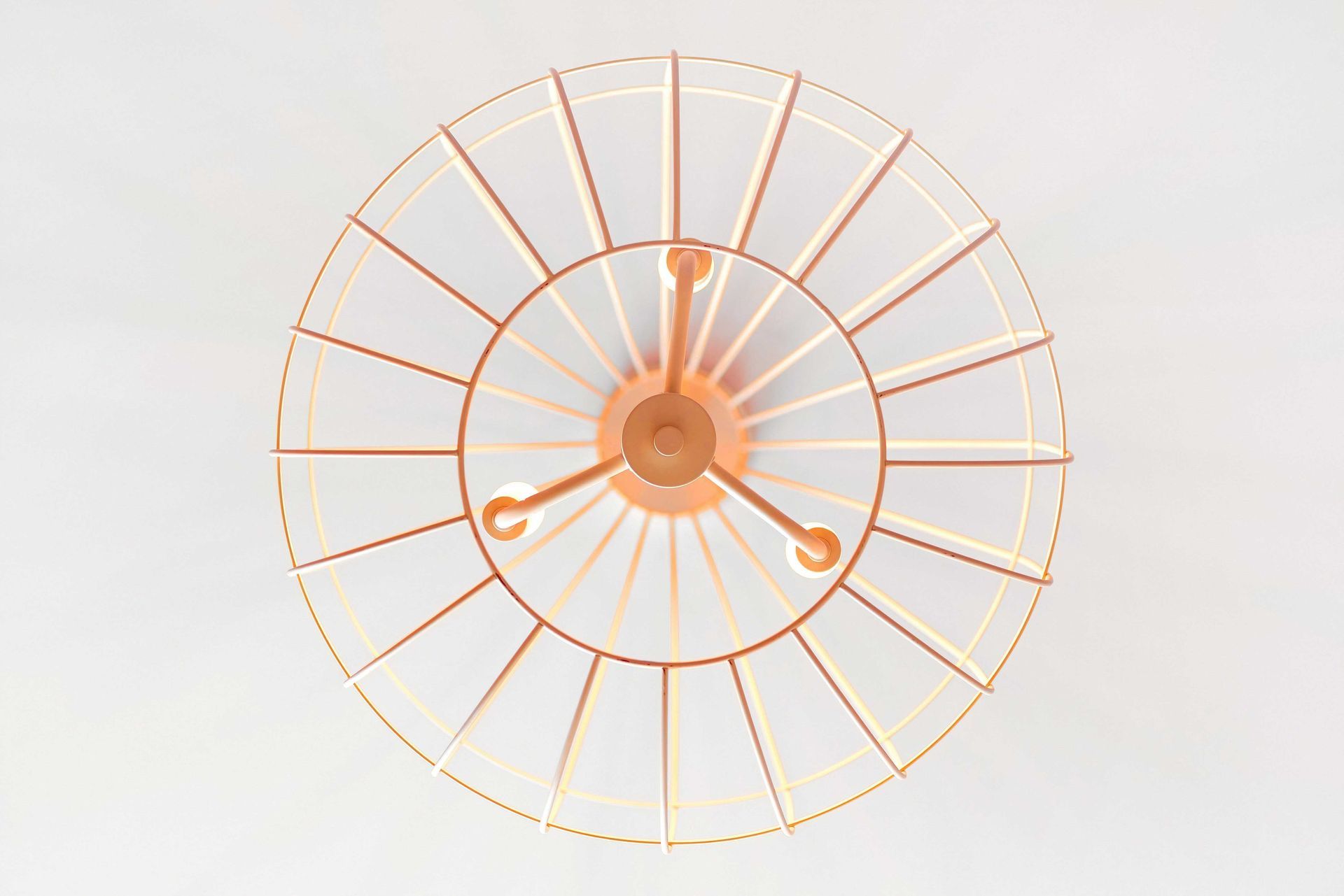 Orange wire cage fan on a white background