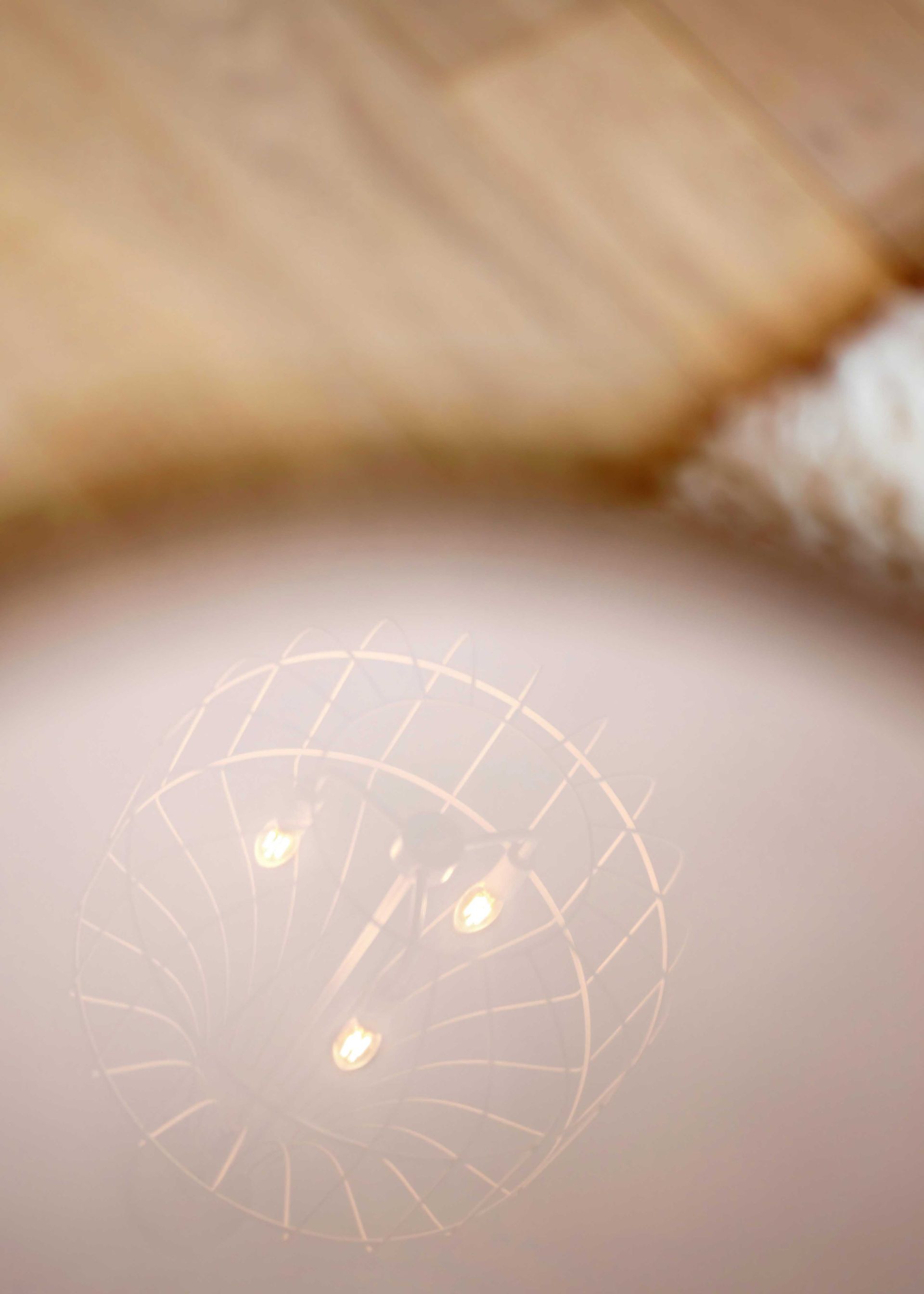 Abstract close-up of a glowing circular light pattern reflecting on a soft beige surface