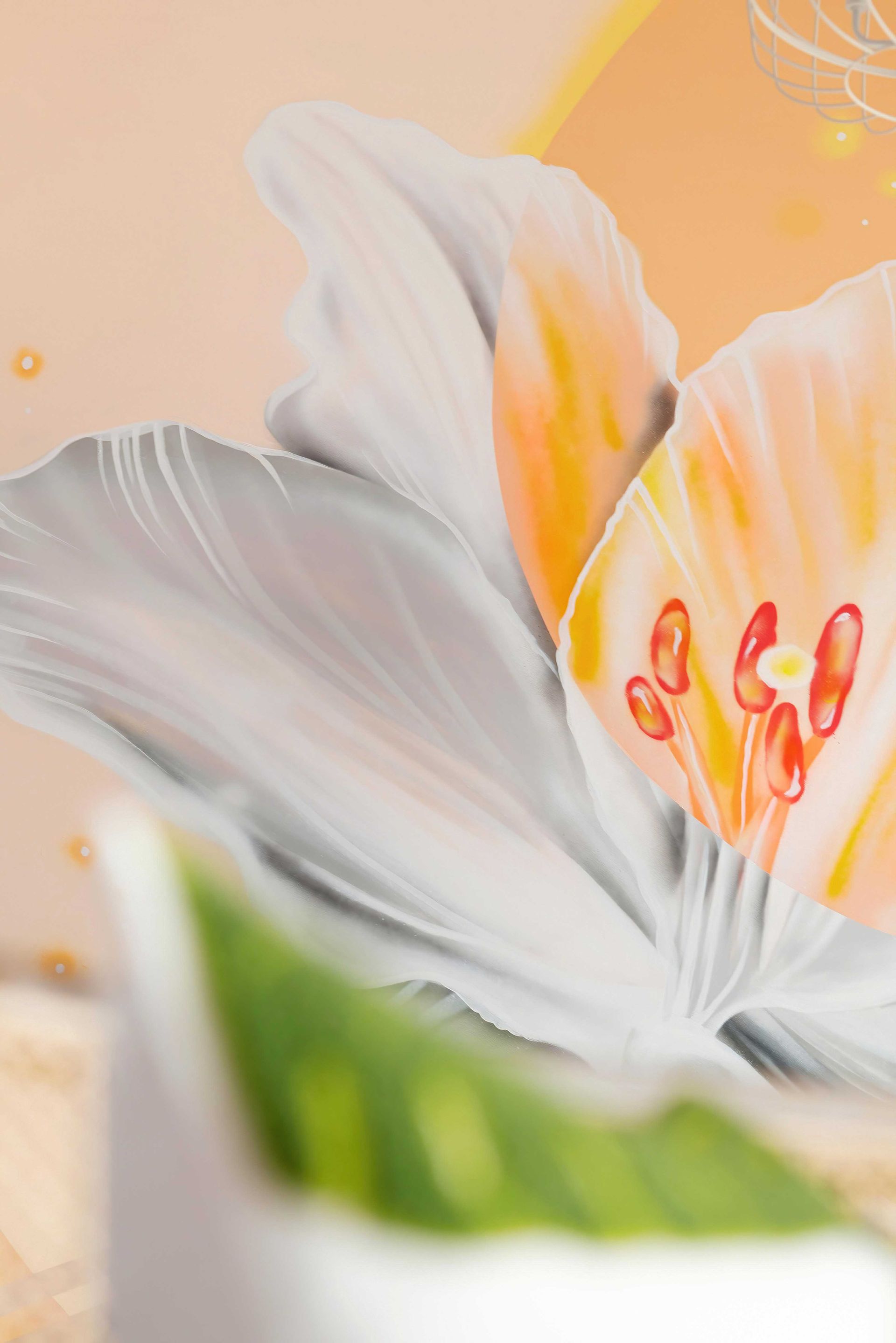 Close-up of a white flower with orange accents and green leaves against a soft peach background