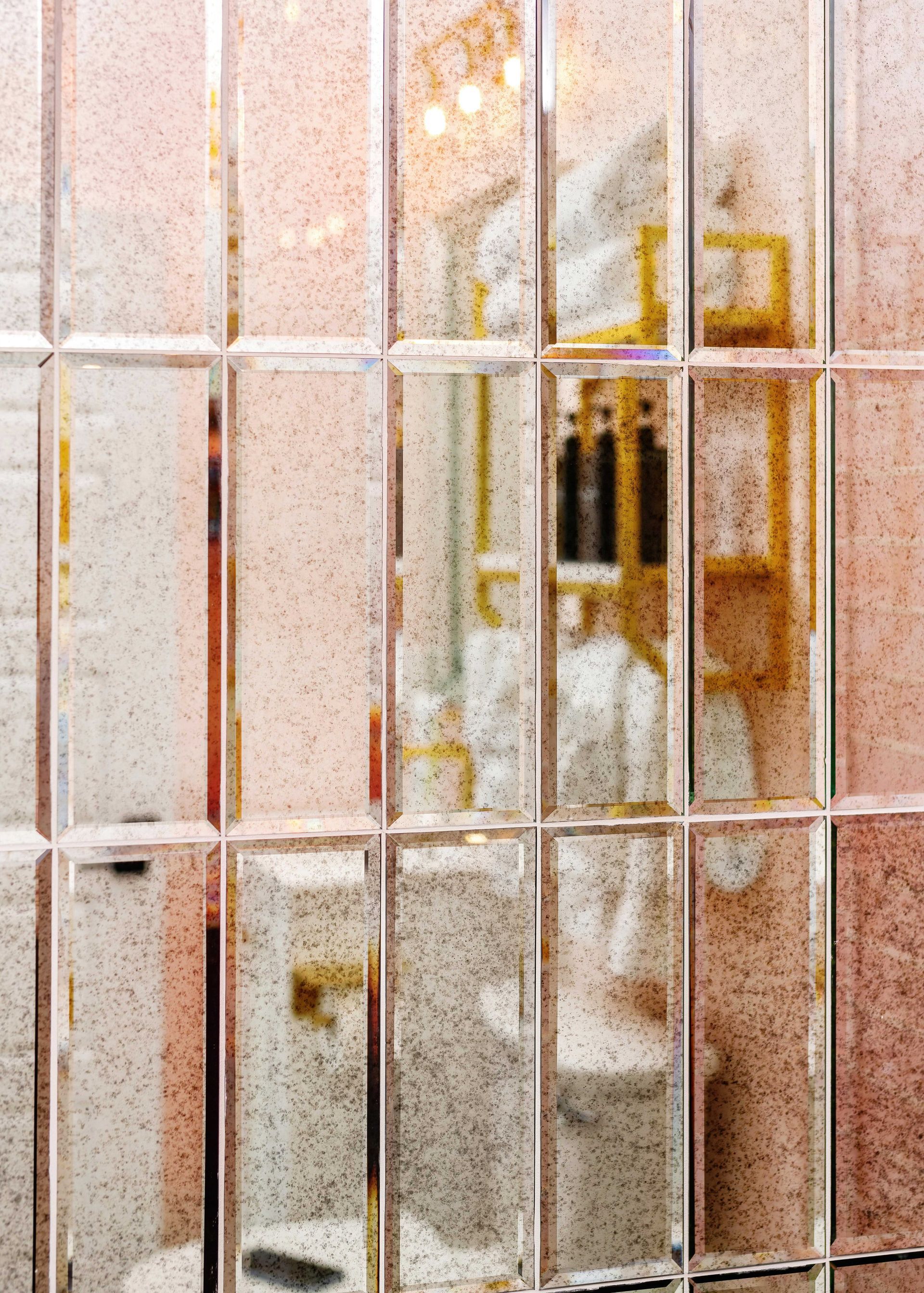 Rusty barred window with a blurred white-and-yellow industrial object behind frosted glass