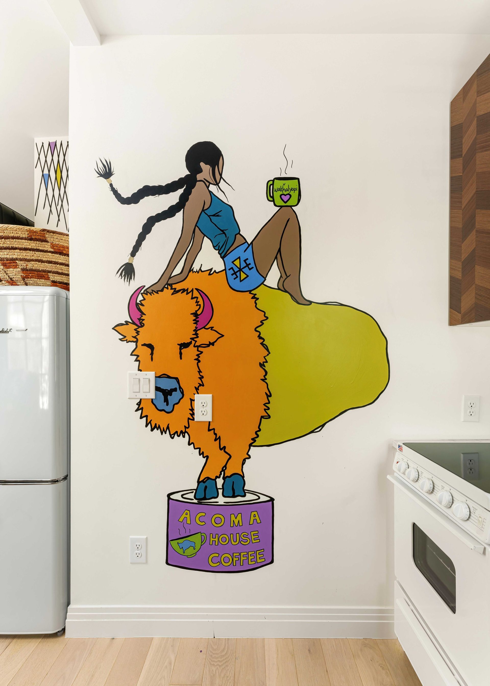 Colorful mural of a stylized person riding an orange lion on a white wall in a room