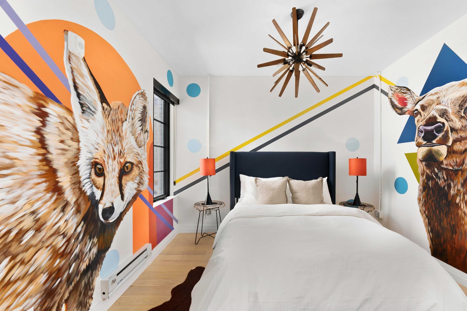 Modern bedroom with animal mural walls, white bed, and geometric decor