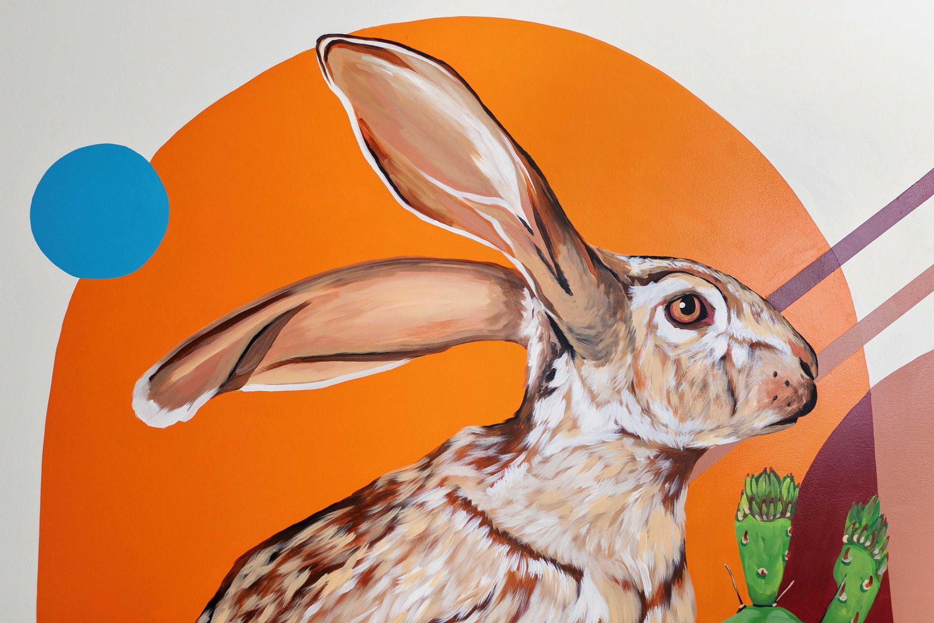 Illustration of a rabbit with long ears on an orange background, with blue and green circular accents