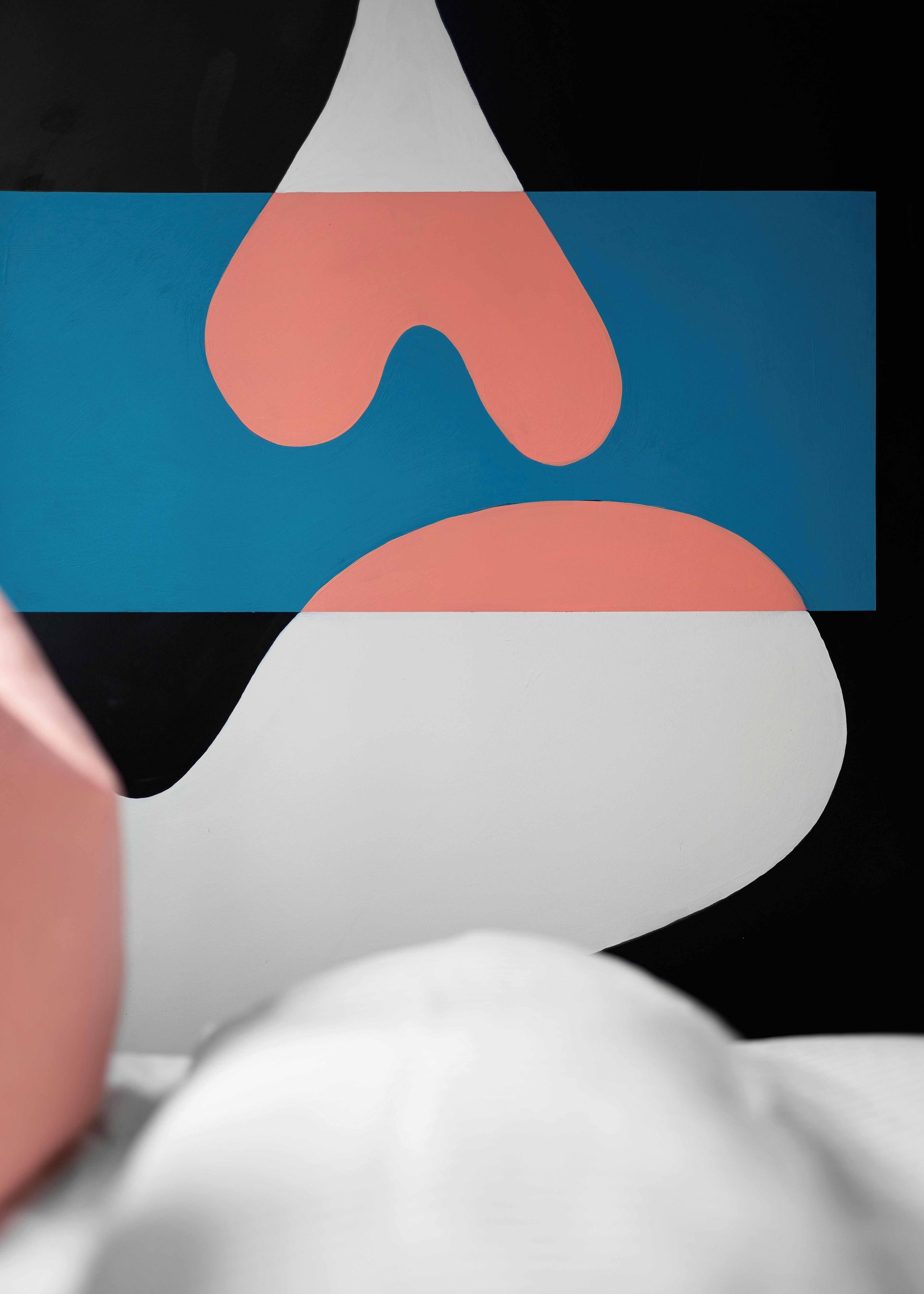 Abstract black, blue, white, and pink geometric shapes on a dark background.